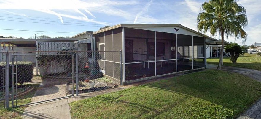 Renovated and ready for new owners!  This charming 1978 manufactured double-wide home in a desirable 55+ community offers an open floor plan, modern updates, and the expansive screened Florida Room extending the living space making it ideal for relaxing and entertaining.  Handicap accessibility throughout this property, low HOA Dues $240 a YEAR, there is NO LOT RENT because YOU OWN THE LAND!  The yard is partially fenced for your pets; 2 maximum with no breed restrictions and no weight restrictions.  Exterior offers long drive way with carport that can cover two cars, two covered porches in addition to the Florida Room and a laundry room/workshop.  Priced to sell - don't miss this opportunity to own an affordable Florida retreat!