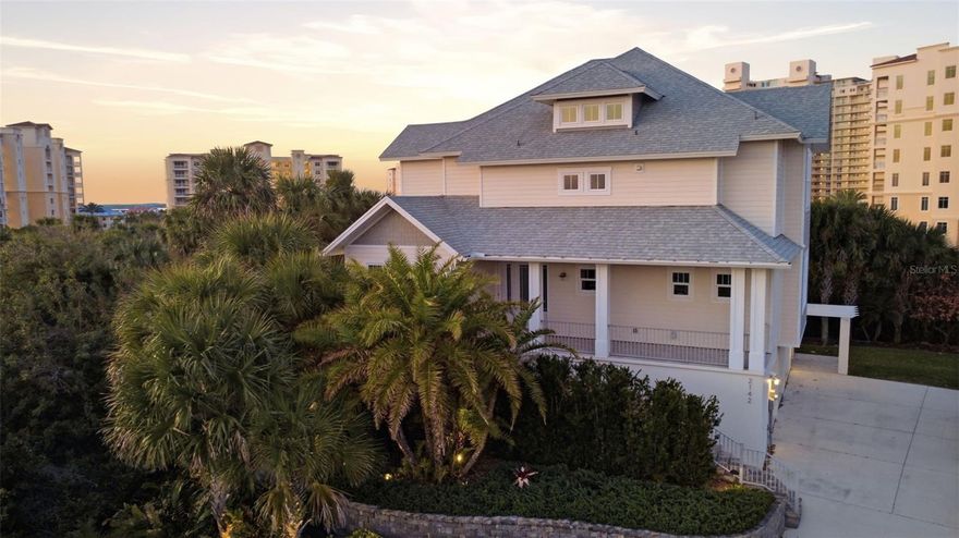 Built in 2018 and lovingly maintained by its original owner, this three-story block home offers 4 bedrooms and 3.5 bathrooms on a rare .31-acre elevated lot in a private, quiet neighborhood of New Smyrna Beach. Enjoy panoramic views of the beach, river, lighthouse, and even toward the shores of Daytona beach from multiple levels and spacious balconies.

The first floor features an expansive ~960 SF 3-car garage with large storage rooms. On the second level, soaring 20+ foot ceilings and ashwood floors create a stunning main living space complete with a natural gas fireplace, impact doors and windows, a natural gas range, laundry room, guest bedroom, full bath, and bonus room/office.

The third floor is highlighted by the primary suite with oversized walk-in closet (including an additional washer/dryer) and breathtaking views, along with an additional en-suite bedroom.

The highly sought-after Minorca community offers residents to enjoy full access to the clubhouse, pool, gym, tennis courts, fishing/boat pier (slips for purchase), plus TV and internet included.

A rare opportunity to own a thoughtfully designed coastal retreat with unmatched views in the city you love, New Smyrna Beach, FL!