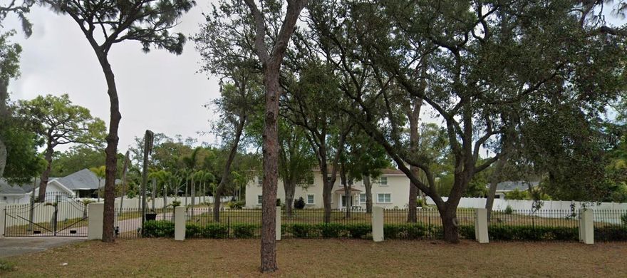PRICED FOR QUICK SALE!!   Rare Masterpiece of Design and Elegance Awaits

Prepare to be captivated by one of the most meticulously crafted and architecturally stunning estates you may ever encounter. Nestled behind private gates on nearly two acres of breathtaking, serene land, this extraordinary residence offers the perfect balance of countryside tranquility and the convenience of one of Tampa Bay’s most sought-after locations.

From the moment you arrive, you’ll be immersed in a world of luxury, sophistication, and timeless design. Interior finishes showcase master craftsmanship—from rich hardwood and natural stone floors to a grand Golden Oak staircase and custom crown molding with ambient LED lighting throughout.

The gourmet kitchen is a chef’s dream, featuring exquisite hand-carved mahogany cabinetry and flowing seamlessly to an outdoor wet bar, expansive private patio, and custom fireplace/grill—ideal for entertaining under the stars.

The layout is as thoughtful as it is beautiful. In addition to two spacious guest suites—each with its own private en-suite bath and walk-in closet—you’ll find a dedicated home office, offering an ideal work-from-home environment.

The master suite is nothing short of palatial, encompassing over 1,200 square feet of refined luxury. Soaring ceilings, a spa-inspired bathroom complete with steam shower and soaking tub, and a dream-worthy walk-in closet create a personal retreat unlike any other. Step out onto your private balcony to take in sweeping views of the lush property and gardens below.

Adding to the estate’s allure is a newly constructed, fully appointed guest house, designed with care to ensure every visitor enjoys the same level of comfort and privacy.

This four-parcel estate is also zoned for horses, offering even more opportunity for those seeking an equestrian lifestyle.   Photos show home as it was when seller purchased it.