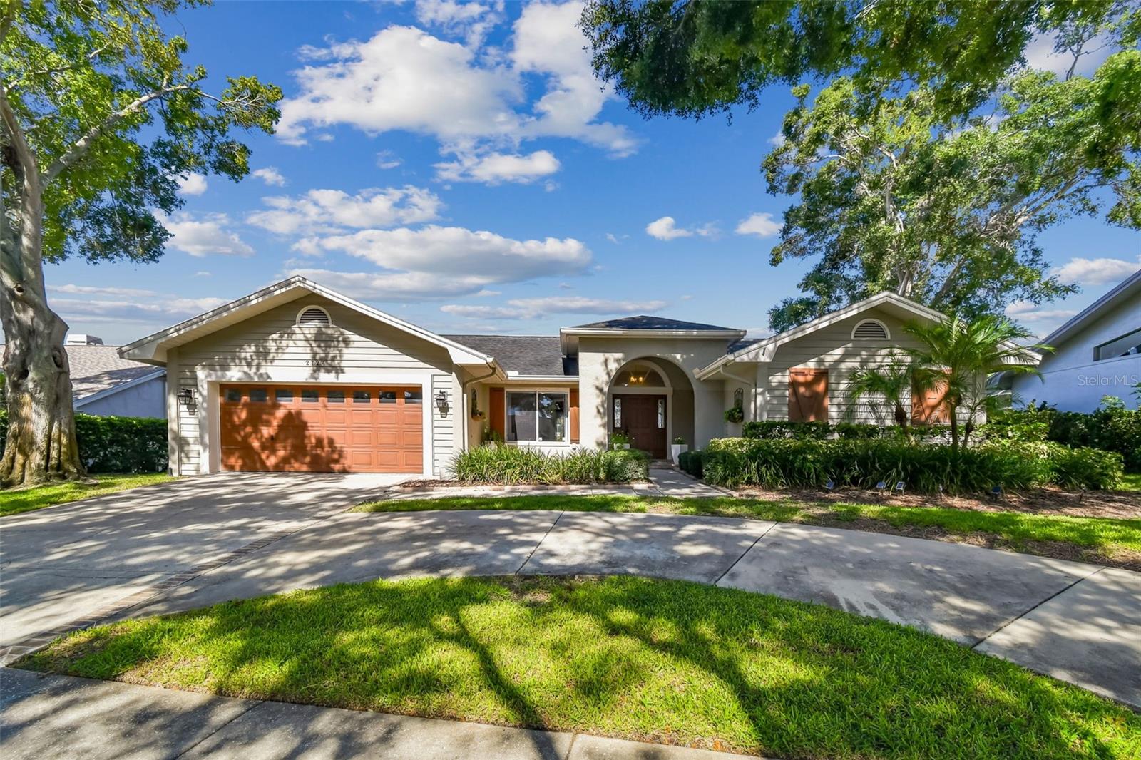 This lovely pool home has been tastefully updated and is ready for move-in. Not in a flood zone, and situated in one of the hottest Palm Harbor neighborhoods, Waterford Crossing, popular due to the excellent location. Located just up the road from the Dunedin Causeway, Honeymoon Island beaches, the Pinellas Trail, Downtowns Dunedin and Palm Harbor, popular local restaurants, shopping and more. Hop on your bike and join the fun! Step into this beauty and discover a light and pleasant environment highlighted by popular updates, a flowing open floor plan, vaulted ceilings, neutral colors and multiple sets of sliding doors that create that special blend of indoor and outdoor living. Sellers installed roof solar panels and enjoy $35.00 electric bills. The updated kitchen is anchored by a massive custom island with plenty of seating, tons of storage and granite tops. Positioned with the open great room on one side and sliding doors open to the covered lanai and pool, the kitchen is set up for convenient living and entertaining. The kitchen also has lovely custom backsplash tile and a walk-in pantry. The primary suite has sliding doors to the covered lanai, a vaulted ceiling, views of the pool AND an updated ensuite bathroom with separate tub and tile shower, linen closet, dual sinks and 2 built-in custom closets. While I'm at it, bedrooms 2 and 3 are nicely sized and EACH has a walk-in closet. The formal dining room is conveniently located to the kitchen and big enough for a large table for entertaining. It also has another set of sliding doors out to the covered lanai. The outdoor living space in this home is what it's all about. The spacious covered living space has room for outdoor family room and dining spaces. The screened pool has tall, volume trusses that encompass the entire pool decking area and covered lanai area. There's lots of decking space (all finished with pavers) around the pool and there is no feeling of the pool being jammed up next to the house. The sellers say they enjoy the best sunsets ever from their lanai. Does this sound like the kind of lifestyle you're looking for? It's special. Living the dream here! Why don't you?