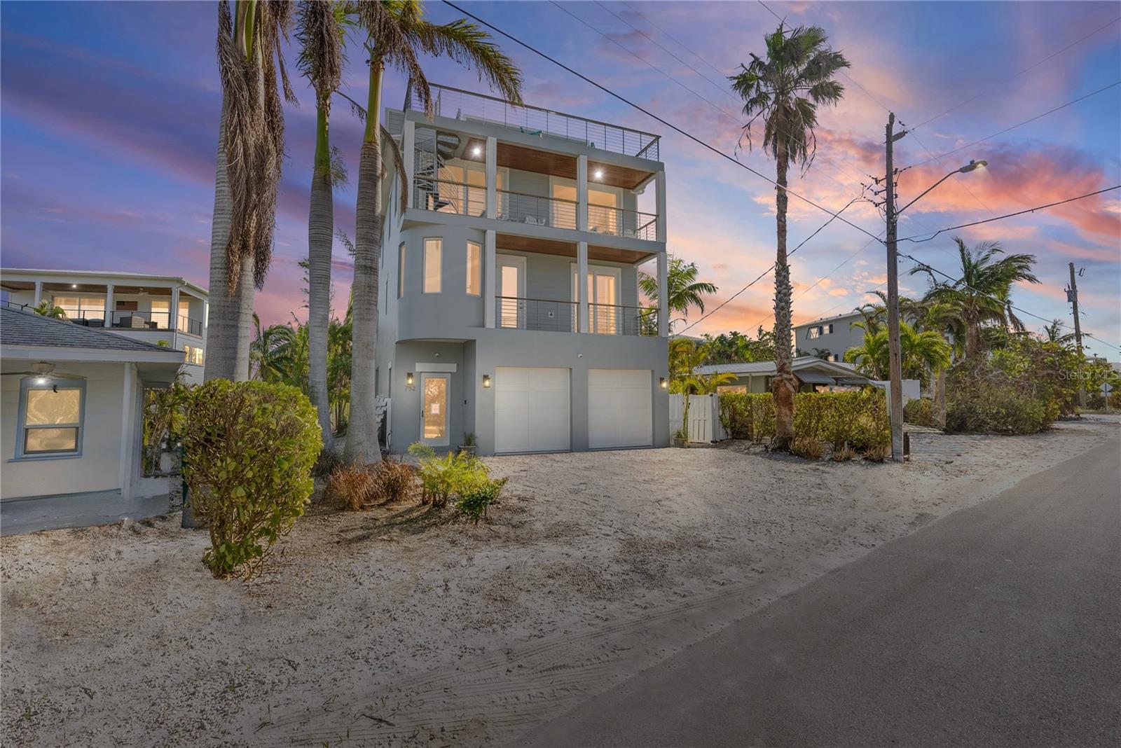 GULF VIEWS, ISLAND LIVING: YOUR COASTAL SANCTUARY W/ CASHFLOW BENEFITS AWAITS
Nestled in the heart of Anna Maria Island, this is more than just a home—it's a breathtaking coastal sanctuary that promises an unparalleled lifestyle of luxury and seaside tranquility. This meticulously designed 2014-built elevated residence spans over 2,500 square feet, featuring five bedrooms and four-and-a-half baths that blend modern sophistication with island charm. The architectural design is a testament to contemporary coastal living, featuring a stunning rooftop deck that redefines the art of sunset viewing. Every detail has been carefully crafted to maximize your connection to the stunning Gulf waters, from the high, airy ceilings to the expansive doors and windows that frame mesmerizing marine horizons.
Imagine ascending to the rooftop sanctuary, where you'll witness breathtaking 270-degree views of the Gulf and surrounding island landscape. Cocktail in hand, you'll watch the sun melting into the Gulf's horizon, painting the sky in vibrant hues of orange, pink, and purple—a daily spectacle that feels both intimate and infinite. The rooftop deck is more than just a viewing platform; it's an entertainment space that epitomizes the ultimate island lifestyle, offering a perfect setting for both quiet contemplation and memorable gatherings with friends and family.
Step outside to an extraordinary outdoor oasis featuring a meticulously crafted travertine paver deck that extends your living space into a luxurious outdoor retreat. The expansive deck surrounds a resort-style heated saltwater pool and an oversized spa with a dramatic spillover feature that creates a mesmerizing water display. A thoughtfully designed sunshelf allows for perfect shallow-water relaxation in that also has a shady spot, providing a perfect spot to cool off while still basking in the warm Florida sunshine. The gourmet chef's kitchen serves as the perfect complement to this outdoor haven, boasting custom solid wood cabinetry, premium stone countertops, a large center island, and top-of-the-line stainless steel appliances—all overlooking the breathtaking Gulf views that transform everyday moments into extraordinary memories.
The property's location is nothing short of perfect, placing you just steps away from Anna Maria Island's most beloved destinations. Practical amenities like a private elevator, hurricane-rated windows and doors, and an oversized two-car garage ensure comfort and peace of mind, while the permitted weekly rentals offer an exciting investment opportunity for those dreaming of owning a piece of this island paradise. This home transcends typical real estate—it's an invitation to live the Anna Maria Island dream, where the rhythm of the Gulf becomes your daily soundtrack and every sunset feels like it was painted just for you. The modern architectural design creates a seamless connection between indoor luxury and the natural beauty of the surrounding landscape.
Whether you're seeking a permanent residence, a vacation retreat, or a strategic investment, this residence represents a rare opportunity to own a true coastal sanctuary. Your Gulf horizon awaits, promising a lifestyle that most only dream about—a perfect blend of luxury, convenience, and the unbridled beauty of island living.