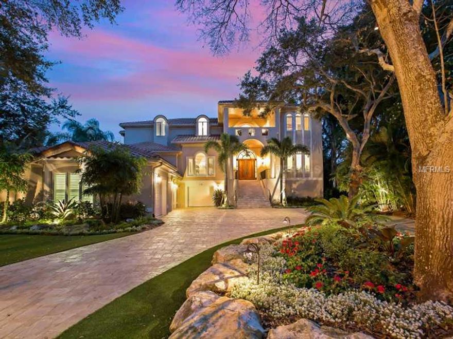 Harbor Acres Bay Front! Enjoy this enviable location on one of Sarasota's signature streets. With southern exposure, a dynamite view, and almost 7,000 sq. ft, this home has been lovingly remodeled with chic interiors and a smart floor plan. Beautiful oak and palm treed lot with new pavered circular drive. Dramatic entry, travertine and wood floors, crown moldings, a guest suite and office on the first level. Grand scaled kitchen with high end stainless appliances and a granite topped eat at bar for 6, breakfast nook and an extensive utility and butler's kitchen are featured. Beautiful sweeping staircase with custom railing leads to three bedroom suites on second level including the master suite with a 17x12 morning kitchen, his and hers baths, two large custom walk-in closets, fireplace and fantastic bay views. There is an additional TV/den area plus loft sitting room. Most rooms open through French Doors onto two terraces across the entire back of the house. Completely new landscaping and hardscape, irrigation, freshly painted in and out, 2 new A/Cs, all new audio/video system with Control 4, heated pool completely remodeled, new outdoor summer kitchen and landscape lighting. Dock with lift. Extensive downstairs storage + 4 car garage.  The Bay Front's best buy.