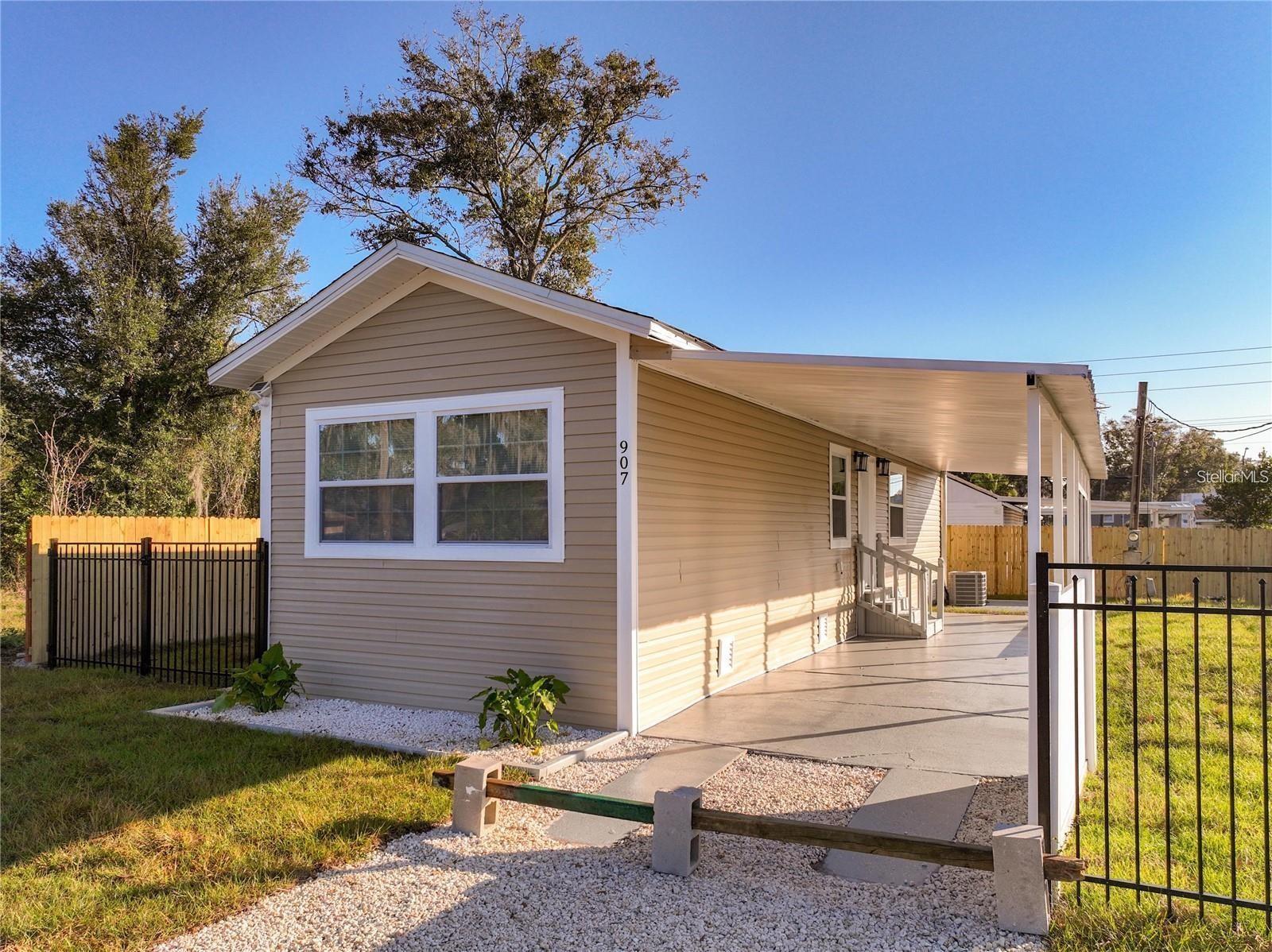 Updated, affordable, and move-in ready! This charming 2-bedroom, 1-bath home sits on a fully fenced lot with NO lot rent and NO HOA, offering true fee simple ownership and low-maintenance living. Inside, enjoy a bright open layout, durable laminate flooring, central A/C, and an upgraded kitchen that flows seamlessly into the main living space. A newly added interior laundry area with a stacked washer and dryer provides modern convenience. Outside, the covered carport doubles as shaded parking or an extended patio. Located just minutes from shopping, dining, and I-4 and under an hour from both Tampa and Orlando. This home is perfect for first-time buyers, downsizers, or investors. Schedule your private showing today!