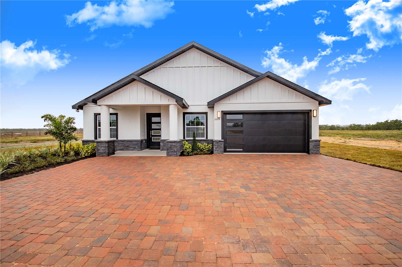 Nestled on over 5 fully fenced acres, this gorgeous 4-bedroom, 3-bathroom home offers the perfect blend of modern elegance and functional living. Boasting high ceilings and an open-concept design, this property is an entertainer’s dream, with plenty of space for both relaxation and enjoyment. Expansive high ceilings throughout the home create a sense of grandeur and openness, complementing the spacious floor plan. The kitchen is a chef's delight, featuring sleek quartz countertops and stainless steel appliances, offering both style and functionality for meal prep and entertaining. Enjoy the convenience of an indoor laundry room, adding practicality and ease to everyday tasks. The entire home is beautifully finished with laminate flooring throughout, combining durability and modern appeal with easy maintenance. Step outside to your own personal retreat with a fully equipped outdoor kitchen under a covered patio, featuring a gas stove, mini fridge, and sink—perfect for cooking and entertaining outdoors. The property spans over 5+ acres and is fully fenced, providing ample space for animals, gardening, or outdoor recreation. An efficient irrigation system ensures that your land stays lush and well-maintained with minimal effort. With its spacious layout, modern finishes, and incredible outdoor features, this home offers the perfect setting for family living and entertaining. Schedule a showing today and see all that this exceptional property has to offer with Modern Features and Stunning Outdoor Space!