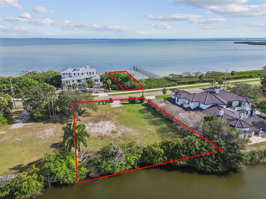 Set along the storied shoreline of South Bayshore Boulevard, 939 S Bayshore Boulevard presents a truly exceptional opportunity to craft a bespoke waterfront estate in one of Safety Harbor’s most distinguished enclaves. This coveted address is defined by grand coastal residences, timeless architecture, and an atmosphere of understated luxury. The offering, an almost one-half acre lot on Alligator Lake (measuring 124 ft x168 ft), is uniquely enhanced by the inclusion of a separately deeded waterfront parcel (measuring 27 ft by 130 ft) directly across the street on Tampa Bay—an extraordinary rarity. This bayfront parcel provides the ability to construct a private dock and/or boat lift, offering direct access to open water, unobstructed bay frontage, and the elevated boating lifestyle that discerning buyers seek yet seldom find. From sunrise reflections on the bay to evening strolls into downtown Safety Harbor, the location seamlessly balances serenity and sophistication. Fine dining, boutique shopping, waterfront parks, and the marina are all within easy walking distance, creating a lifestyle that is both refined and effortlessly convenient. Surrounded by multi-million-dollar estates and positioned within one of Pinellas County’s most desirable waterfront corridors, this property represents a premier canvas for luxury new construction—where architectural vision meets enduring value, privacy, and the unmistakable allure of Tampa Bay. Do not delay as opportunities like this are not recreated—only claimed.