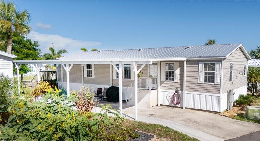 WATERFRONT LIVING AT ITS BEST – LAND OWNERSHIP! NO LOT RENT! Don’t miss this rare opportunity to own a beautifully maintained 3-bedroom, 2-bath home in Pelican Harbor Mobile Home Estates, one of the area’s most desirable 55+ waterfront communities. Perfect for boating, kayaking, and fishing enthusiasts, this property delivers the ultimate blend of comfort, convenience, and coastal lifestyle.
Inside, you’ll find a spacious split floor plan filled with natural light. The primary suite features a walk-in closet and ensuite bath with dual sinks, soaking tub, and separate shower. The bright, open kitchen offers ceramic tile flooring, an eat-in bar, and abundant cabinet space. A dedicated laundry room adds everyday convenience. The bonus room expands your living area with sliders that open to a massive deck overlooking the water—a perfect spot for entertaining or simply enjoying the view. Upgrades include a metal roof, new spray foam insulation underneath, and newer A/C for improved energy efficiency. Enjoy the expansive open porch—ideal for relaxing or entertaining—along with your private dock, boat lift, and seawall for effortless waterfront access. Additional features include a new 48x16 covered carport with electrical. Community Amenities: Heated pool and clubhouse, shuffleboard, horseshoes, bocce ball, designated RV/trailer/boat storage, and inclusive water, sewer, and trash services. Ideally located near shopping, golf courses, entertainment, and top-rated dining—and just an hour to the world-famous Siesta Key Beach—this home offers both a serene retreat and an active waterfront lifestyle. Schedule your private showing today and experience the best of Florida living!