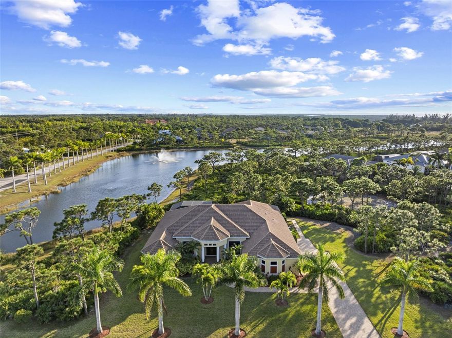 Discover a rare offering on Pine Island, an immaculate custom estate set on an expansive 1.2-acre homesite in Calusa Ridge, one of Bokeelia’s most sought-after nature-preserve communities. Elevated on a natural ridge in Flood Zone X (12 to 17 feet above sea level) with no flooding from recent storms, this property offers both peace of mind and a stunning private setting overlooking a quiet preserve and lake. Inside, the home feels bright, open, and welcoming with soaring 10 to 12 foot ceilings, abundant natural light, illuminated alcoves for artwork, and luxurious finishes throughout. The main living area includes a formal dining room and a convenient half bath for guests. The spacious kitchen is designed for those who love to cook and gather; it offers solid wood cabinetry, granite counters, a large island with seating, double ovens, stainless steel appliances, and ample space for a dining table and has an adjoining sitting area. A Butler’s pantry with wet bar and pass-through, along with a large laundry room, complete the thoughtful layout. The home includes two impressive primary suites, each with direct access to the pool area. The main suite feels like a private retreat with an oversized walk-in closet, an additional linen closet, and a spa-inspired bath featuring a jetted stand-alone tub, a generous shower, dual vanities, and a separate WC. Two additional bedrooms each have their own private full bathrooms, offering comfort and convenience. A fourth bedroom works perfectly as an office or den and is located just across the hall from the half bathroom. A disappearing slider opens to more than 1,000 square feet of fully screened outdoor living space finished with 20/20 super screens and elegant pavers. The heated saltwater pool is ideal for lap swimming and features newer Pentair equipment and night lighting. The outdoor area also includes a full bathroom and a well-appointed kitchen with a JennAir grill, downdraft, bar seating, and a fridge, perfect for relaxed evenings overlooking the lake and its illuminated fountain. Built in 2014 and exceptionally cared for, the home includes a long list of high quality upgrades. It features hurricane-rated windows and doors, a roof with a third nail and two new Carrier HVAC systems installed in 2025. The exterior was freshly painted in 2023, the septic was pumped in 2023, and the irrigation system draws from lake water. Underground utilities, a six-acre community lake with a gazebo, lush tropical landscaping, and a paver driveway add to the appeal. Calusa Ridge offers a quiet, naturally beautiful setting close to marinas, fishing, and waterfront dining, just under two miles from the Marina for easy boating access. This home offers a stunning blend of quality, privacy, and thoughtful design. Your slice of island paradise awaits.