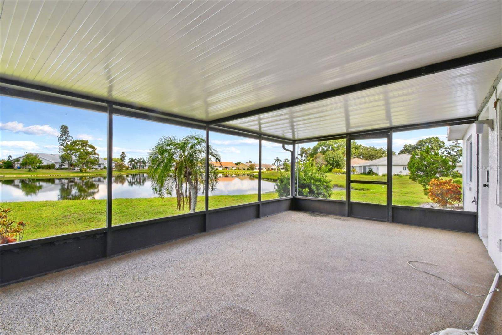One or more photo(s) has been virtually staged. Welcome to 912 East Del Webb Boulevard – a BEAUTIFULLY MAINTAINED HOME on a DOUBLE LOT with WATER VIEWS in the heart of Sun City Center! This MOVE-IN READY 2-BEDROOM, 2-BATH home sits on an OVERSIZED 0.28-ACRE LOT and offers GORGEOUS WATER VIEWS from the LARGE COVERED & SCREENED-IN BACK PATIO. With 1,598 SQ FT OF HEATED LIVING SPACE, there’s plenty of room to relax, entertain, and enjoy the FLORIDA LIFESTYLE. Best of all, EXTERIOR LANDSCAPING IS MAINTAINED BY THE HOA, making for EASY, LOW-MAINTENANCE LIVING. The ROOF WAS REPLACED IN 2024, and the home features ENERGY-EFFICIENT LOW-E DOUBLE-PANE WINDOWS and SOLAR PANELS for long-term utility savings. The CUSTOM-REMODELED KITCHEN is a showstopper, complete with ALL-WOOD CABINETS, STAINLESS STEEL APPLIANCES, FRENCH DOOR REFRIGERATOR, CUSTOM CEILING WOODWORK, GRANITE COUNTERTOPS, and a BUILT-IN PANTRY. You’ll love the OPEN-CONCEPT LIVING AREA with UPDATED LAMINATE FLOORING throughout the main space. The PRIMARY BEDROOM includes an UPDATED ENSUITE BATHROOM with a WALK-IN SLIDING GLASS SHOWER and VANITY, while the SECOND BEDROOM has its own REMODELED FULL BATH with NEW VANITY and a TUB/SHOWER COMBO. Other standout features include a NEWER WATER HEATER, a 2-CAR GARAGE, and a ROCK WRAPAROUND DRIVEWAY ON THE SIDE LOT offering AMPLE PARKING for guests, a golf cart, or even a small boat or RV. As a resident of SUN CITY CENTER – ONE OF FLORIDA'S TOP 55+ COMMUNITIES, you'll enjoy an ACTIVE LIFESTYLE with access to INDOOR & OUTDOOR POOLS, TENNIS, FITNESS CENTER, SPA, LIBRARY, ARTS & CRAFTS, OVER 200 CLUBS, LAWN BOWLING, and MUCH MORE. GOLF CARTS are the preferred mode of transportation, and this home is just a SHORT RIDE TO GROCERY STORES, BANKS, RESTAURANTS, and RECREATIONAL FACILITIES. You’re also in a PRIME LOCATION with CONVENIENT ACCESS TO TAMPA, SARASOTA, AWARD-WINNING BEACHES, AIRPORTS, DINING, SHOPPING, ENTERTAINMENT, and PROFESSIONAL SPORTS VENUES.