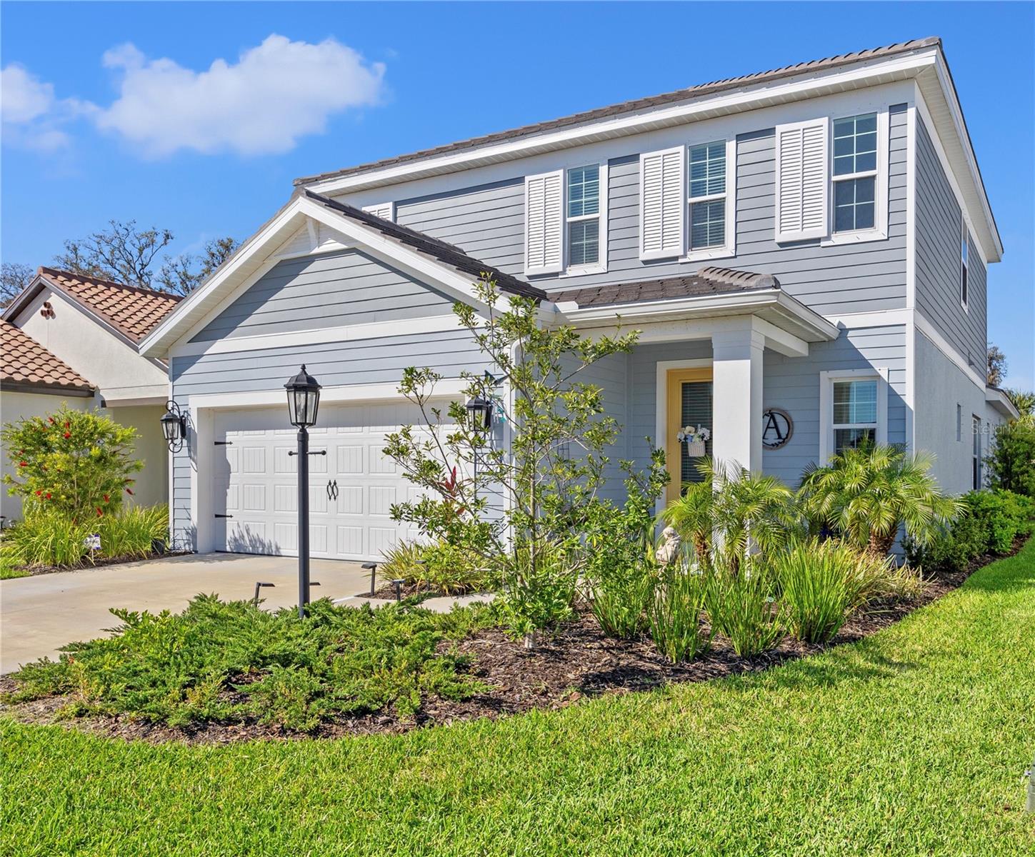 Step into this stunning open-concept 2023-built “Heritage” home, perfectly situated on a quiet cul-de-sac in the sought-after Lakewood Ranch village of Indigo. With 4 bedrooms, 2.5 baths, and a spacious 2-car garage, this two-story residence offers a modern design, luxurious upgrades, and an unbeatable location near A-rated schools, Bob Gardner Park, and two Publix grocery plazas.
Inside, the Great Room welcomes you with soaring tray ceilings and stylish luxury flooring, creating a seamless flow throughout the main living area. At the heart of the home, the gourmet kitchen is designed for both style and functionality. The oversized island with quartz countertops, custom cabinetry with glass accents, and sleek stainless steel appliances set the tone for a high-end feel. Contemporary pendant lighting adds a touch of sophistication, while the walk-in pantry with a stylish glass door provides ample storage. Cooking is effortless with a gas range, built-in microwave, deep sink, and elegant white cabinetry accented by a modern backsplash.
The main-floor owner’s suite is a private retreat featuring sliding glass doors leading to the backyard patio, a spa-like ensuite with dual sink vanities, a large walk-in closet, and a spacious corner shower. Upstairs, a versatile loft space is perfect for a recreation room, second living area, or home office. Three additional bedrooms offer ample space, bedrooms 2 and 3 to bring in Florida’s natural light. This home is equipped with a state-of-the-art UV air purification system integrated into the HVAC, using ultraviolet light technology to help eliminate airborne bacteria, viruses, and allergens—ensuring cleaner, healthier air throughout the home.
Beyond the home’s interior, Indigo offers resort-style amenities, including gated entry, two community pools, a fitness center, pickleball courts, playgrounds, sidewalks throughout, and an on-site lifestyle director who plans events for residents. LOW HOA fees of $404 per month cover all these amenities, plus exterior lawn maintenance and irrigation.
Don’t miss this opportunity to own a modern, move-in-ready home in one of Lakewood Ranch’s premier communities! Schedule your private showing today.