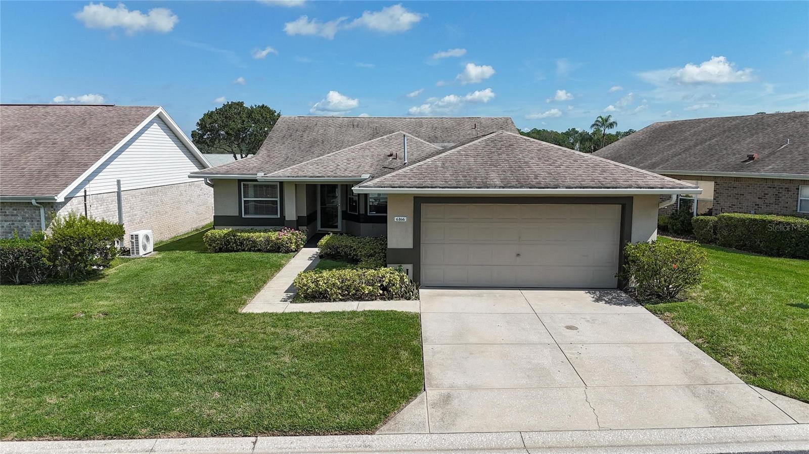 Charming 3 bedroom, 2 bath, 2 car garage home with 1,335 sq ft of living space in Silver Lakes, an active 55+ gated community. As you step inside you are greeted by the light-filled living room and dining room with vaulted ceilings and sliding glass doors that open to the screened lanai. The screened lanai is perfect for morning coffee, entertaining, or simply enjoying the Florida sunshine. The master bedroom offers serene lake and fountain views, private access to the screened lanai, a large walk-in closet, dual sinks, and a ceramic-tiled shower. Two guest bedrooms are located on the opposite side of the home, connected by a Jack and Jill bathroom with a tub and shower combo, and one of the guest suites features water views with direct access to the screened lanai. Newer luxury vinyl plank flooring flow throughout the main living areas with ceramic tile in the wet spaces—no carpeting in this home! Updates also include newer ceiling fans in every room and on the lanai, a new garbage disposal, updated kitchen and bathroom faucets and a new microwave. The spacious eat-in kitchen has plenty of cabinet and counter space, and an inside laundry room is conveniently located just off the kitchen with access to the garage. All the furniture is included in the sale, making this home truly move-in ready so you can start enjoying the Florida lifestyle from day one. Forget about yard work and pool maintenance—the low HOA fee of $225 a month includes cable, internet, lawn care, and reclaimed irrigation water. Instead, enjoy the resort-style amenities including a heated junior Olympic-sized swimming pool, hot tub surrounded by a beautiful paver patio, a clubhouse with fitness room, sauna, library, and kitchen, plus walking paths around three lakes. Silver Lakes is pet friendly, golf card friendly and conveniently located near shopping, restaurants, medical facilities, and I-4 for easy access to Tampa, Orlando, and Disney attractions. Experience carefree Florida living at its finest and call today to schedule your private showing.