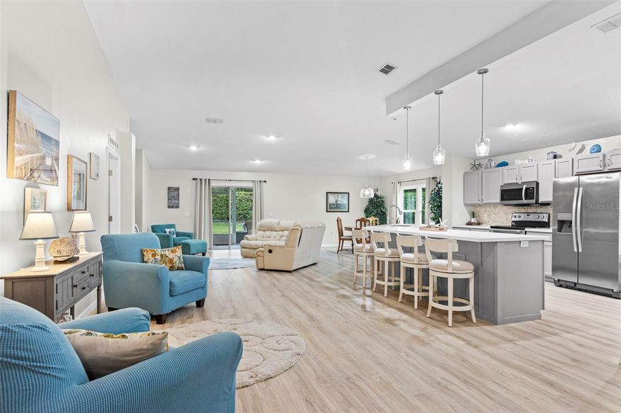 Meticulously maintained Majestic Oaks 3 bd/2 bath home on a private outside corner lot. 2025 ROOF & 2022 IMPACT WNDOWS w/ transferable warranties. AC 2021. Gorgeous laminate wood flooring with open concept, soaring ceilings, large kitchen Island, Coffee bar & beverage cooler complete the design! The primary bdrm offers updated tile shower and walk-in closet. Whole house water filtration, can lighting on the peaceful & spacious lanai, gutters and downspouts 2021! Salt water community pool is heated. Low HOA dues: does all lawn maint, just competed new street asphalt & sprinkler systems.