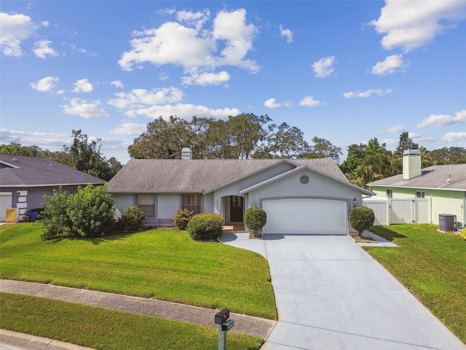 Welcome to your pleasing 3-Bedroom, 2-Bath Home in Explorers Cove. Nestled in the charming Tarpon Springs, Florida, this delightful residence is merely a short walk from Fred Howard Park and Beach, as well as the Gulf of Mexico—more recently known as the Gulf of America where boating and jet skiing can easily become your favorite activities. Additionally, this home is conveniently located near golf courses, parks, restaurants, and the world-renowned Sponge Docks, making it an ideal spot for everyone. As you enter, you’ll be welcomed by a spacious family room filled with natural light. During the cooler holiday season, enjoy cozy evenings by the warm fireplace. If you love entertaining friends and family, this home is perfectly suited for you! Preparing and cooking in the kitchen is a breeze, allowing for enjoyable conversations over drinks in this practical and expansive space. You’ll find both a formal dining room and a eat in dining area within the kitchen, complemented by beautiful, ample cabinet space and granite countertops.
The master suite serves as a tranquil retreat, featuring its own en-suite bathroom complete with a luxurious soaking tub and a separate shower. The two additional generously sized bedrooms share a bathroom, making them ideal for family or guests.
Outside, the backyard is partially fenced and boasts a patio, perfect for entertaining or unwinding after a long week of work with mature landscaping and space for a garden or play area, this outdoor environment is not only spacious but also beautiful. This meticulously maintained home is a single-owner property, showcasing a brand new HVAC system and a new dishwasher.
Whether you’re savoring a morning coffee, cruising downtown in your golf cart for dinner, or taking a sunset stroll on the beach, you’ll discover everything you need for a vibrant and fulfilling life in Tarpon Springs. This home in Explorers Cove is more than just a place to live; it’s a true gem. Call and schedule your showing appointment today to experience it for yourself!