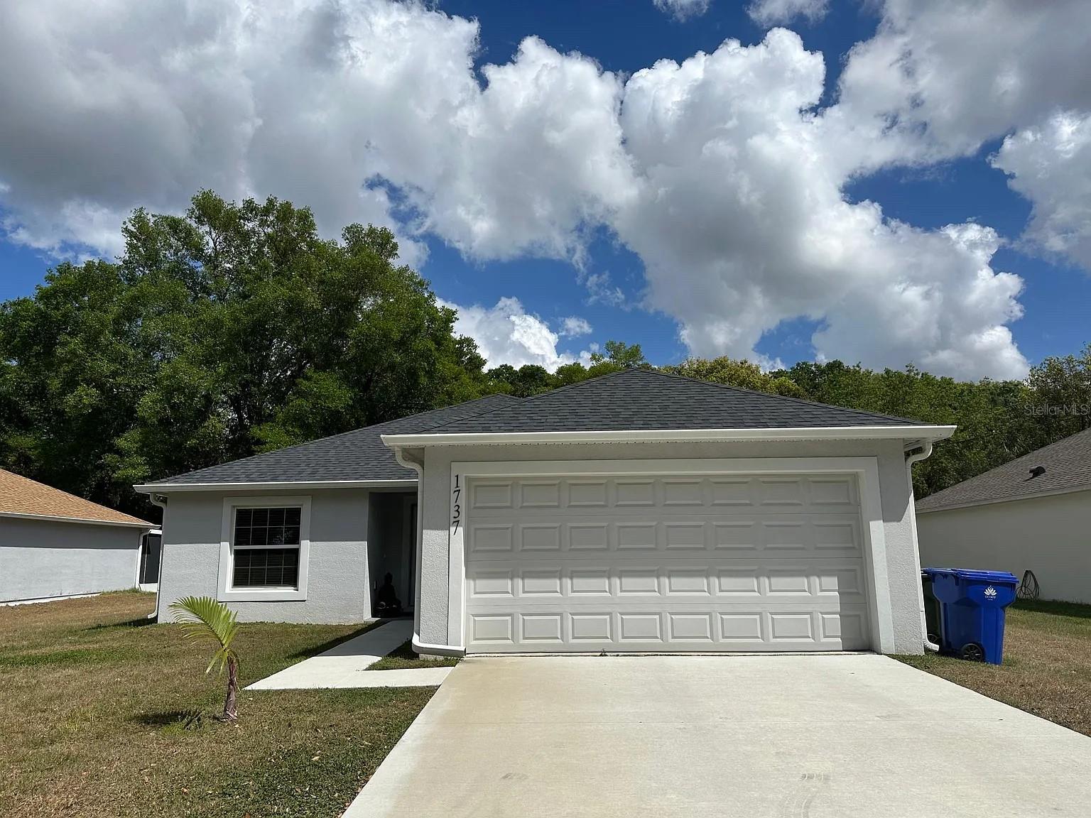 Beautiful one-story vaulted ceiling home! 3 bedroom & 2 bathrooms with large walk-in closets in every room! Great location for the Innovation Montessori School in Ocoee! The home features plenty of natural lighting, upgraded modern ceiling fans w/ remote, upgrade lighting, custom cabinets in the laundry room, wood style vinyl floors, custom white cabinets & stone countertops. Enjoy the roomie backyard & location! The garage has custom overhead storage & spacious driveway. Just down the street you can enjoy the new Ocoee Village. Energy efficient home on septic! Washer & Dryer included in laundry room. (Please note that the refrigerator in the home is not the one in these photos. Laundry room has different washer & dryer than these photos.) This home won't last long!
