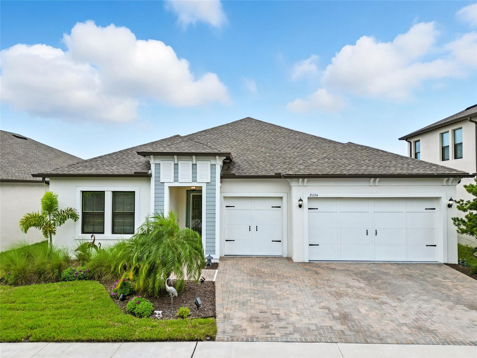 Welcome to this stunning 4 bed, 3 bath, 3 car garage, pool home that has been thoughtfully upgraded and beautifully maintained in the esteemed Connerton Community. From the moment you arrive, the custom glass front door and fully covered porch create a warm and inviting entry. Step inside and you’ll be greeted by a built-in office nook off the hallway, perfect for today’s flexible lifestyle. Entertain effortlessly with its expansive open-concept living space, seamlessly flowing into a stunning kitchen designed to impress. Featuring a 5-burner gourmet cooktop, upgraded GE stainless steel dishwasher, double ovens, an abundance of cabinets, a large island bar, a coffee bar, and a striking counter-to-ceiling custom tile backsplash—this kitchen is equal parts functional and stunning. Custom pendant lights and fixtures add a touch of elegance, while the dining space ensures you’re always ready to host family and friends. The primary suite offers a true retreat with its massive custom walk-in wardrobe and a spa-like ensuite bath complete with dual vanities, a glass-enclosed walk-in shower, and a soaking tub for unwinding after long days. Three additional bedrooms and two more full bathrooms provide ample space for family or guests. Step outside and picture yourself entertaining or simply relaxing in your private backyard oasis. A 12’ x 30’ custom Gunite saltwater pool with auto vacuum is ready to help you relax, enclosed in a screened lanai with a covered patio lounge area. The spacious yard extends beyond the pool, and the fully fenced backyard offers both privacy and room to play. Even better, all newer pool furniture and a Blackstone gas grill are included—ready for your first gathering. The Connerton Community offers a ton of high-class amenities for the whole family including multiple pools, a splash park, clubhouse, park + playground, fitness center, basketball court, tennis court, volleyball court, and 10 miles of scenic trails. With close proximity to the Tampa Premium Outlets, the Groves Gold & Country Club, and the onsite Elementary School for little ones, this is more than a home—it’s a lifestyle, blending luxury upgrades, thoughtful design, and an outdoor haven you’ll never want to leave.