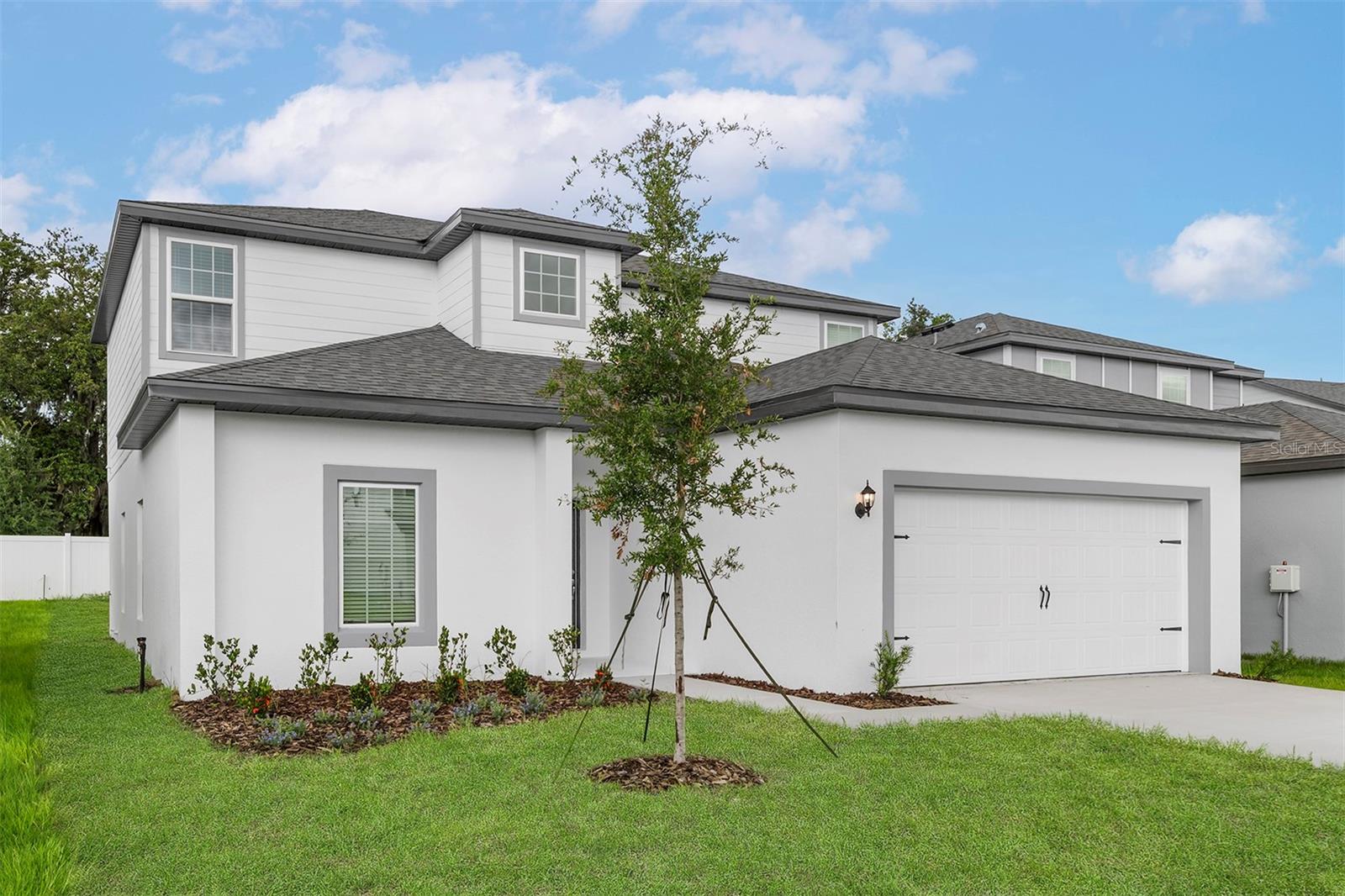 Pre-Construction. To be built. Welcome to the Useppa model, a stunning 5-bedroom, 2.5-bathroom two-story home located in the highly desirable Tula Parc community of Astatula, FL. With no rear neighbors, this home offers a peaceful backyard setting and extra privacy—perfect for relaxing or entertaining.
From the moment you arrive, you’ll be impressed by the exceptional curb appeal and mature front yard landscaping. Step inside to discover a thoughtfully designed layout with spacious living areas, a private flex room, and an upstairs game room—offering endless possibilities for family life, hobbies, or entertaining guests.
The open-concept main floor features a large family room, a chef-ready kitchen with granite countertops, and a separate dining area that’s perfect for gatherings. The kitchen is beautifully appointed with 36” upper wood cabinets with crown molding, Whirlpool® energy-efficient appliances (refrigerator, microwave, dishwasher), LED flush-mount lighting, and a walk-in pantry.
Retreat to the private master suite, complete with a massive walk-in closet, dual-sink vanity, and a step-in shower, designed to help you unwind in comfort. All five bedrooms are generously sized, offering space for every member of the household.
This home also includes luxury vinyl plank flooring, a programmable thermostat, designer coach lights, double-pane low-E vinyl windows, and a Wi-Fi-enabled garage door opener for modern convenience.
Located in Tula Parc, you’ll enjoy access to a community gazebo and playground, and be just minutes from the Chain of Lakes and Little Lake Harris, where you can enjoy boating, fishing, kayaking, and more. Plus, Orlando’s shopping, dining, and theme parks are just a short drive away.
Don’t miss your chance to own this move-in-ready Useppa model—a perfect combination of space, upgrades, and tranquility. Schedule your private tour today!
