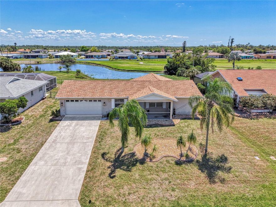 If you are looking for a home on the golf course with a lovely water view, without breaking the bank, this is one you will want to check out.  Located on the 8th hole of The Hills Golf Course in the popular deed-restricted community of Rotonda West, this 2 bedroom, 2 bath, 2 car garage home has had many updates, and is just waiting for someone to add their personal touch.  A new roof was put on in 2024, and a new AC system and Water Heater were installed in August of 2020.  Recent updates this year include new solid shaker-style wood kitchen cabinets with soft-close doors and drawers, new quartz kitchen countertops, a new garbage disposal, new carpeting in the primary bedroom, as well as a new bathroom vanity and quartz countertop.  New ceiling fans and new window blinds have also recently been installed.  The home features ceramic tile throughout the house (except for the primary bedroom), a split bedroom floorplan, and sliding doors to the ceramic tiled lanai.  Enjoy Rotonda's 165-acre community park, 30-mile fresh water canal system and excellent golf courses, along with the area's sparkling intercoastal waterways, beautiful Gulf of Mexico beaches, miles of walking and biking trails, tennis courts, restaurants, shopping, and world-class fishing.  Make your appointment today!  Time to enjoy the Florida sun!