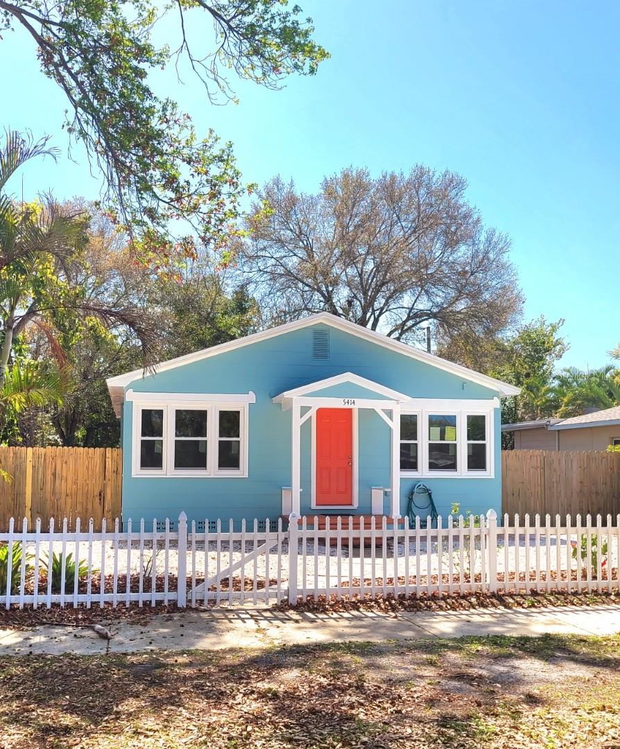 Step into this spacious, charming traditional bungalow that seamlessly combines old-world charm with modern amenities. Updated with elegant LED ceiling fans and lighting throughout, this home boasts a prime location in a non-flood zone, just a short stroll from downtown Gulfport and Tomlinson Park. Inside, discover an exceptional layout designed to maximize space efficiency. Enjoy abundant natural light streaming through 19 new, high-impact, energy-efficient Simonton windows (one currently undergoing installation, expected completion within a week). With a new roof in place, benefit from reduced insurance premiums thanks to comprehensive wind mitigation features.
The bungalow's interior is bathed in light, accentuating beautiful hardwood floors and tiled surfaces in the kitchen and bonus room. Step outside to a charming side patio, perfect for al fresco dining. The large eat-in kitchen features granite countertops and brand-new appliances, while an irrigation well and pump ensure lush landscaping with minimal effort. Professionally landscaped front and side yards require little maintenance, enhancing the home's curb appeal. An attached garage accessible from the alley offers convenience with an automatic door opener, LED lighting, washer/dryer hookups, and a laundry sink/work area (currently undergoing epoxy floor coating). The fully fenced yard provides security and privacy. Additional features include a new water heater, a 5-year-old AC unit under warranty, and ample space in the side yard for potential pool installation. Located in a friendly neighborhood with sidewalks, this home offers the perfect blend of comfort, convenience, and style.