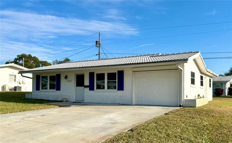 Welcome to Tamarac By the Gulf, a desirable 55+ Seminole community where an active lifestyle meets comfort and convenience. Designed for those looking to enjoy retirement to the fullest, this welcoming neighborhood offers a wide variety of social activities, clubs, and events, making it easy to stay engaged and connected with neighbors. One of the standout features of this community is its exceptionally low HOA fee, thoughtfully managed by the community itself through dedicated volunteers helping keep costs down while maintaining a well-cared-for environment. The dues include maintenance of the common grounds, reclaimed water system and roads, two days for trash pick-up, one day recycling pick-up, potable water/sewer, house painting, roof cleaning, clubhouse with a pool, library, shuffleboard, horse shoes, billiard table, table tennis, and a full schedule of activities. The lawn care consists of mowing, lawn pest/weed control, fertilizer, sprinkler system, and reclaimed water. Perfectly located just 3 miles from the beach, you’ll enjoy quick access to the Gulf and will be centrally situated near shopping, dining, and an abundance of medical facilities. With tile floors throughout and updated kitchen and bathroom, this home is ready for you to enjoy. There is a half bath located just off the bonus living room along with the laundry room.  The AC was updated in 2019 to include a separate mini-split unit in the bonus room for added comfort and efficiency. Also, a tankless water heater and newer energy efficient impact windows and slider, that are Miami-Dade compliant, will help you save on those energy bills and create peace of mind. The tile roof was replaced in 2014. An oversized single garage (25 feet long - NEW DOOR) with an electric roll down screen makes for a great place to relax on a nice day or create your own workshop with plenty of storage. If you’re looking for an affordable, active, and friendly retirement community in the heart of Seminole, this home offers the ideal blend of location, lifestyle, and value.