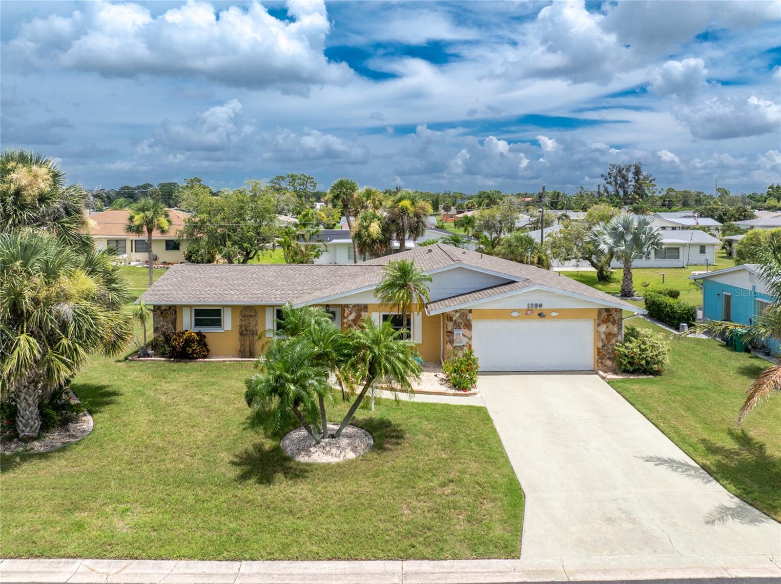 IF YOU WANT A MOVE-IN READY HOME, LOOK NO FURTHER! Starting with the great curb appeal, this home will please even the pickiest of buyers! IMPACT WINDOWS AND DOORS, IMPACT OVERHEAD GARAGE DOOR, NEW AC (2024), NEW ROOF (2020), REPIPED OVERHEAD, ALL NEW KITCHEN (CABINETRY AND COUNTERTOPS, UPDATED BATHROOMS, AND TILED FLOORING THROUGHOUT! This open floor plan features a spacious living room with sliding glass doors to the Family room, and formal dining area with two corner cabinets, great for displaying your favorite dishware. The kitchen is light and bright, with soft close doors and drawers, decorative upgraded granite countertops, box ceiling w/ceiling fan, recessed lighting and double door pantry. Appliances include: smooth top stove, microwave, dishwasher, and French door refrigerator. (all LG). The primary bedroom has a stylish barn door, wall closet, ceiling fan, and en suite primary bath. The Primary bath has an all new shower stall, pretty vanity w/solid surface countertop, and linen closet. The GUEST BEDROOM - on the other side of the house- could actually be a 2nd Master suite, as the Guest Bath is immediately adjacent. Guest bedroom features a walk in closet and ceiling fan, and Guest Bath has a combo tub/shower (tub has been reglazed), new toilet, and linen closet. The versatile Family room is so light and bright and has a ceiling fan and door to the Lanai. The oversized two car garage houses the washer and dryer, utility tub, storage closet and lots of extra storage! The lanai is a great place to enjoy morning coffee or an evening glass of wine, while relaxing in your SALTWATER HOT TUB! Get the grill fired up and enjoy kicking back out on the patio, on those cooler Florida eveningsThe pretty backyard is the icing on the cake, with vinyl privacy screen between you and your backyard neighbors. Seriously, THIS HOME WILL NOT LAST LONG! Buy now while you can and start enjoying FLORIDA SALT LIFE!