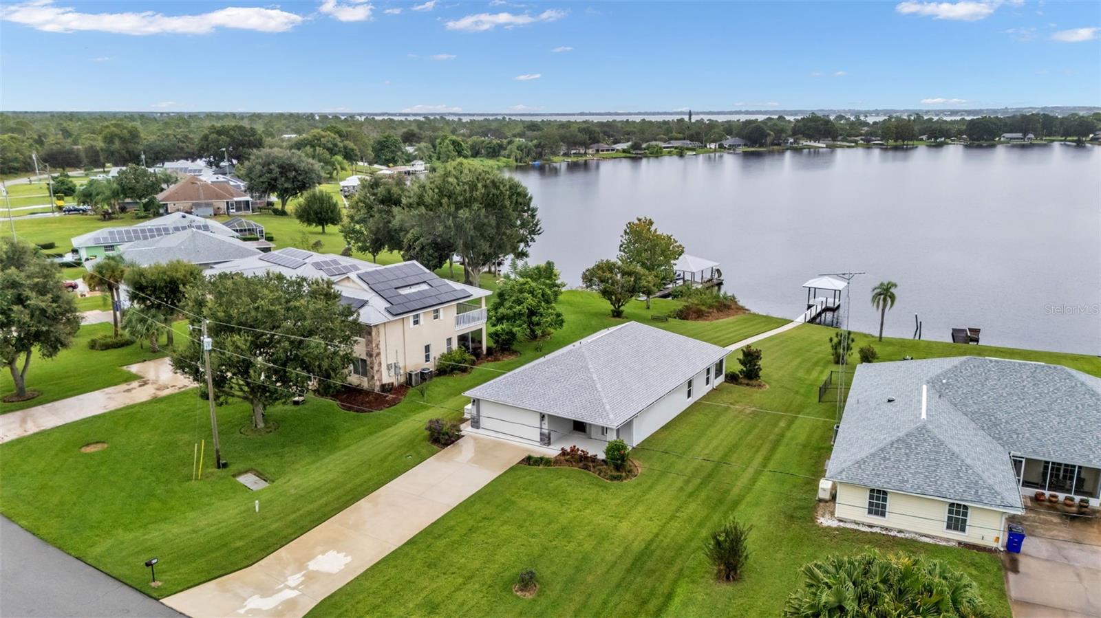 Wait until you pull up to this move- in ready LAKEFRONT dream home! Built in 2021 the sellers have spent just a minimal amount of time here making this home basically BRAND NEW! Not just that, but upgraded appliances and fixtures throughout! Located on the peaceful shores of Lake August, where you can enjoy unforgettable sunsets every evening! This home is a 3 bedroom, 2 bathroom, 2 car garage home that is tastefully decorated with high- end decor and has been meticulously kept. The home comes with a whole house Generac Generator ensuring you'll never lose power during any of Florida's unpredictable storms. The screened in patio and the private dock are the perfect spots to enjoy a cup of coffee in the morning or a glass of wine in the evening while watching those sunsets. The Dock and gazebo are built with PVC decking. There’s a walk in shower in the primary bath and porcelain tile in the guest bath, tile baseboards in both bathrooms, PGT hurricane windows & sliding glass door, 5" baseboards throughout, and IMPACT THERMA FRONT ENTRY DOOR. The AC comes with a 10 year labor warranty that is transferable to the new owner! There is a sprinkler system that is well-fed. Lake August offers calm, no wake water -great for fishing, kayaking, paddleboarding, or a leisurely boat ride. This is the perfect home whether you're looking for a full time residence, part time getaway, or a turn key AirBnB this lakefront retreat offers it all!