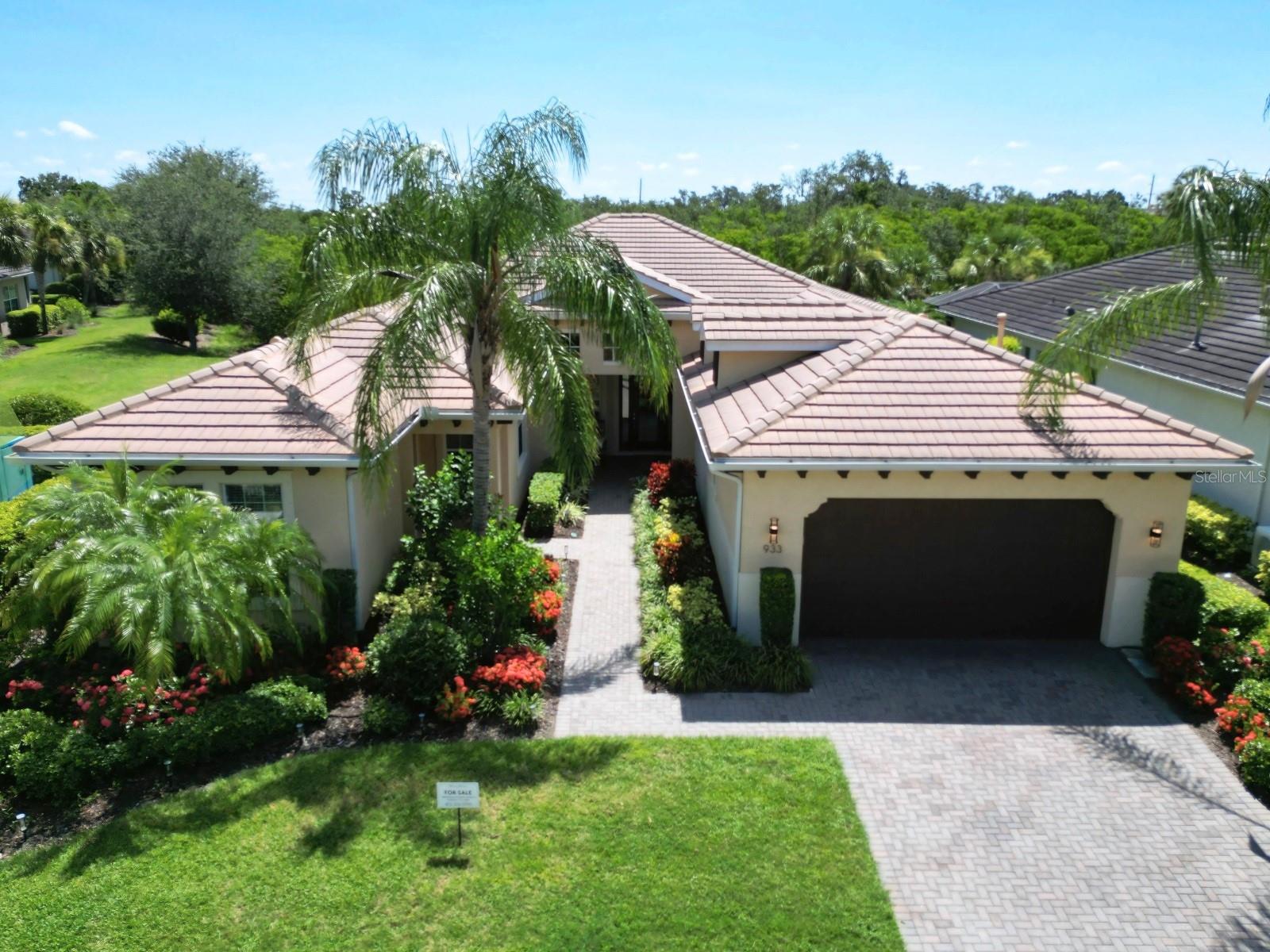 Welcome to The Waterside Escape, a standout gem in the exclusive, 24-hour guard-gated Tidewater Preserve community—a riverfront paradise where luxury meets versatility. Priced to impress as the best value in the neighborhood, this immaculate 4-bedroom, 3.5-bath home offers a unique feature that sets it apart: a private mother-in-law suite with its own entrance. Perfect for multi-generational living, an adult child, visiting friends, or family, this thoughtfully designed wing elevates this property into a one-of-a-kind retreat. Tucked away on the first floor, the mother-in-law suite is a spacious, self-contained haven with its own wing and open floorplan. Featuring a separate entrance for ultimate privacy, this versatile space is ideal for guests, extended family, or even a home office or studio. Paired with the home’s elegant design—high soaring ceilings, graceful arched doorways, and premium tile and luxury vinyl flooring (no carpet!)—this suite adds a layer of functionality that’s hard to find. Beyond the suite, the main home dazzles with an open-concept layout perfect for entertaining. The chef’s dream kitchen is the heart of it all, boasting sleek stainless-steel appliances, granite countertops, a generous island, and ample cabinetry—ready for everything from casual dinners to grand gatherings. Flowing seamlessly into the great room and dining area, this space opens to an extended lanai through oversized glass sliders, where lush tropical views create your own private oasis. Sip coffee at sunrise or toast the sunset in a setting that feels like a permanent vacation. Retreat to the luxurious master suite, a royal escape with soaring ceilings, expansive walk-in closets, and a spa-like en-suite. Relax in the soaking tub, refresh in the oversized shower, or enjoy the dual vanities—all framed by tranquil views with no neighbors in front or back. Nestled along the Manatee River, Tidewater Preserve delivers a resort-style lifestyle: a private marina with Gulf access, a heated pool at The Lodge, a fitness center, tennis courts, kayaks, and a dog park—all surrounded by scenic nature trails. Maintenance-free landscaping (included in HOA fees) keeps the lush exterior pristine, while the paved driveway welcomes you home. Plus, you’re just minutes from I-75, top dining, shopping, beaches, healthcare, and airports. With its rare mother-in-law suite, luxurious finishes, and unbeatable location, The Waterside Escape is more than a home—it’s a lifestyle tailored to you. Don’t miss your chance to own this waterfront treasure.