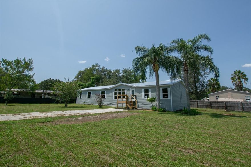 Newly renovated! 4-bedroom 2 bath home just under 2000 sq ft located on corner lot 0.35 acre. This home can accommodate a larger family within the home as well as ample space for outside activities or relaxation. The large kitchen is centrally located in the heart of the home where family tends to congregate and spend a lot of time is a great feature with a living room and a family room for additional spaces for families to gather or to entertain guests. The upgraded kitchen has All new appliances, beautiful new epoxy countertops, kitchen island and breakfast bar. LVF luxury vinyl plank flooring installed throughout the home with the look of wood but is waterproof. A fireplace to cozy up to in the colder months. The home has cathedral ceilings, newly painted interior, new ceiling fans and light fixtures. The four-bedroom split plan can accommodate a larger family or provide extra space for guests or a home office.  Both bathrooms have been updated. The master bath has a walk-in shower and separate large garden tub. Brand new roof installed 8/17/2023. Newly painted exterior. Newly fenced in yard. Country living feel that is close to all the conveniences, shopping and only a few minutes away from Ridge Rd extension for easy access to the Suncoast Expressway to Tampa airport and surrounding areas. No HOA fees. Bring your toys! Moon Lake subdivision offers a community lake, playground, picnic area and a free boat ramp to the public.