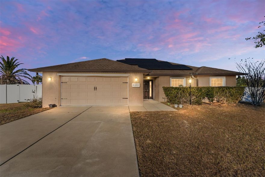 Tucked away on a quiet cul-de-sac in the Meadow Glenn community of Ocala, this well-cared-for Fallon model offers comfortable living on an oversized .36-acre lot with a thoughtful blend of style, space, and functionality. With three bedrooms, two baths, and a two-car garage, this home is designed for both everyday living and easy entertaining. From the moment you enter, the welcoming foyer with wainscoting detail and a coat closet with custom built-ins sets the tone. Vaulted ceilings and tile flooring throughout the main living areas enhance the open, airy feel, while the bedrooms feature plush carpeting for added comfort. The kitchen flows seamlessly into the living and dining areas and is beautifully appointed with granite countertops, staggered cabinetry with crown molding, stainless steel appliances, and a brand-new dishwasher. Pendant lighting above the breakfast bar and additional lighting over the dining area create a warm, inviting atmosphere, while the walk-in pantry provides ample storage. The living room offers a ceiling fan, TV mount, and sliding glass doors that open to the covered back porch, perfect for indoor-outdoor living. The spacious primary suite serves as a private retreat, featuring a ceiling fan, blinds, a large walk-in closet, and an ensuite bath with double granite vanities, a linen closet, and a tiled, glass-enclosed walk-in shower with built-in bench. Two additional bedrooms are comfortably sized and include ceiling fans, blinds, and ample closet space. The second bathroom is equally well finished with a granite vanity, tiled tub/shower, and its own linen closet, complemented by additional hallway linen storage. The laundry room adds everyday convenience with tile flooring, a utility sink with lower cabinet, and a new Whirlpool washer and Kenmore dryer that convey with the home. Step outside to enjoy the covered back porch with ceiling fan, overlooking a fully vinyl-fenced backyard with both double and single gates, offering flexibility for pets, storage, or recreational use. Gutters surround the home, and a Ring doorbell adds an extra layer of security. Set on a generously sized lot in a peaceful setting, this home offers the space, features, and added benefit of solar-powered efficiency you’ve been looking for! Schedule your private showing today.