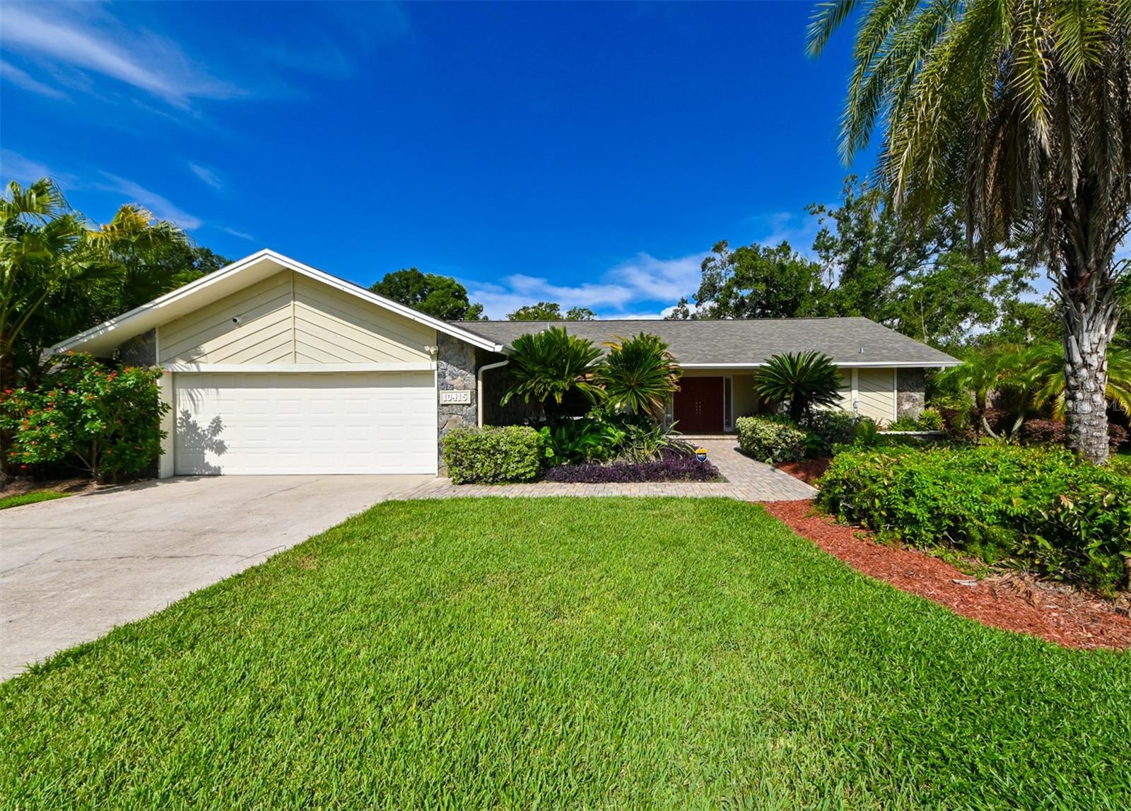 Welcome to Burnbrook, a private enclave of Old Carrollwood with fewer than 30 homes set on peaceful, oversized lots. This 4-bedroom, 3-bathroom heated-pool home sits on a 14,550 sq. ft. (.33 acre) lot, offering incredible curb appeal with mature Florida landscaping, paver walkway/patio, a brand-new roof (2025), and an expansive driveway that can accommodate over six vehicles. Step through impressive double doors into a home designed for Florida living, with a split floor plan and pool views from multiple rooms. The private primary suite features a large ensuite bath, 2 walk-in closets, and direct pool access. A formal living room with pocket sliders sits just off the primary, offering flexible use options. At the heart of the home, the kitchen boasts granite countertops, new stainless steel appliances (2024), hardwood cabinets, an island, a passthrough window to the pool deck, and direct access to the family room. Here, another set of pocket sliders and a cozy fireplace with built-in shelving create an inviting gathering space. Three spacious guest bedrooms and two full baths, one with direct pool access, are located on the opposite wing. Outside, enjoy a screened-in pool deck ideal for entertaining, plus a paver lanai with a jacuzzi for cooler evenings. A new fence (2024) encloses the backyard for privacy and security. Major recent updates include: new roof (2025), plumbing supply lines (2015), fence (2024), pool pump (2024), jacuzzi pump & cover (2024), pool heater (2021), HVAC (2020), water heater (2025), garage door (2019), kitchen appliances (2024), fresh interior paint (2025), and exterior paint (2021). Full upgrade list available upon request. Perfectly situated in the highly desirable Carrollwood area, you’re minutes from parks, restaurants, golf courses, and top-rated schools, with easy access to all of Tampa Bay. Schedule your showing today!