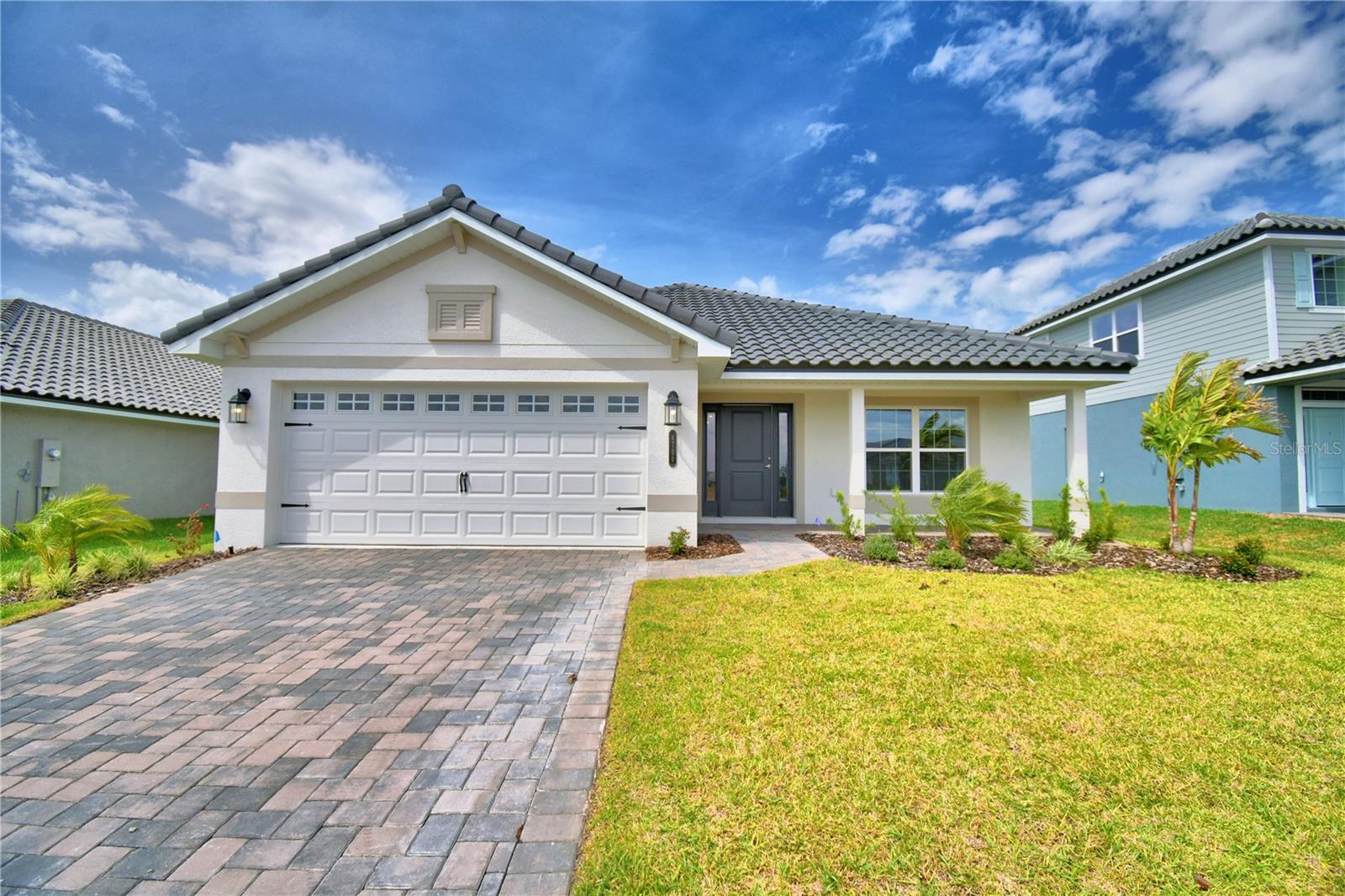 Under Construction. This 2200 Sq ft home has 4 bedrooms and 3 baths, 2 car garage, lots of entertaining space and luxurious details throughout! Upon entering you will enjoy the open concept great room/dining room/kitchen with 10’ ceilings, wood look plank tile in main areas, granite countertops throughout, 5 ¼ inch baseboards, wainscotting in dining room and much more. The owner suite is spacious with Tray Ceiling w/crown molding. Ensuite has double sink vanity with extra storage drawers, linen closet, tile separate shower w/glass door, nice tub, etc. The home also has a second owner suite with ensuite and a large walk-in closet. 2 other bedrooms in the home share a oversized bath with linen closet, tub-shower combo, separate toilet, double sink vanity with storage drawers. The exterior of the home has a tile roof and patio paver driveway, and patio paver covered lanai. This community is gated, has a gorgeous clubhouse with fitness center, pool overlooking the lake, basketball court, tennis court, playground, and community boat ramp. Photos are of a finished 2200 . Actual colors and finishes may vary.