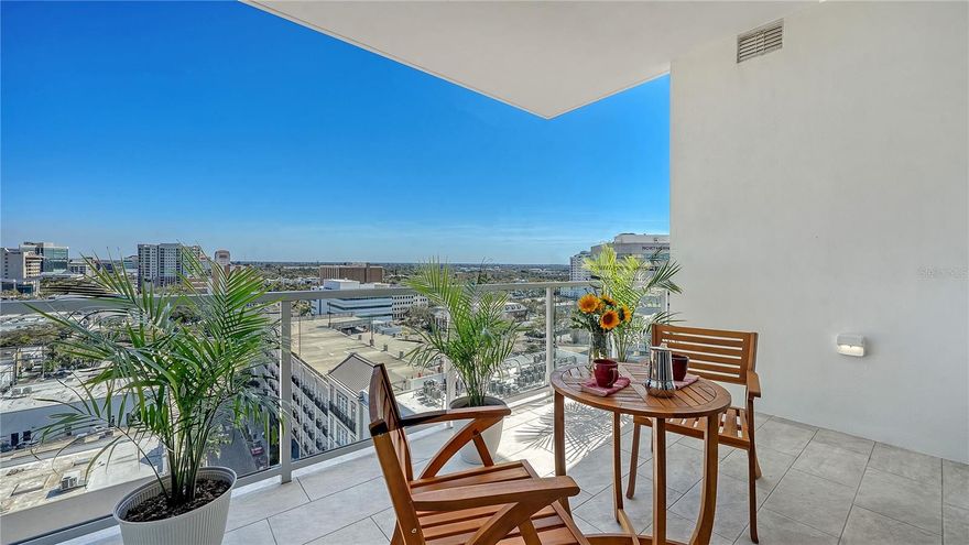 Recently enhanced with thoughtful upgrades and design refinements, this 11th-floor residence at The Mark Sarasota presents an elevated, move-in ready opportunity in the heart of downtown. A brand-new shower in the primary suite, refreshed finishes, and carefully curated improvements complement the home’s architectural integrity, further elevating its refined modern aesthetic.

Perfectly positioned above the city, this exceptional condominium spans approximately 1,600 square feet and is defined by 10-foot ceilings, floor-to-ceiling windows, and a seamless connection to Sarasota’s skyline. East-facing exposure fills the residence with natural light, while expansive glass frames dynamic urban views from nearly every room.

The open-concept layout flows effortlessly from the sleek entry into the living, dining, and kitchen areas. Gallery-style walls and sculptural architectural elements create a striking backdrop for art, while hickory hardwood flooring extends throughout, reinforcing the home’s cohesive and contemporary design. Carefully selected color accents and tailored detailing enhance the residence’s clean lines.

At the center of the home is a custom European kitchen from Germany, designed with precision and minimalist sophistication. This distinctive culinary space features smooth cabinetry, a solid applewood island, half-inch stainless-steel countertops with an integrated sink, and professional-grade Miele appliances—including a convection steam oven, induction cooktop, and dishwasher—alongside a Sub-Zero refrigerator and reverse-osmosis water filtration system. The kitchen blends performance and artistry, anchoring the residence’s modern design.

The adjoining living area incorporates custom built-ins for concealed media storage and display, while a sculptural bookshelf subtly defines the dining space—creating an inviting setting for intimate gatherings or evening entertaining. A thoughtfully designed inglenook adds warmth and dimension, anchored by a sleek Evonic fireplace, built-in shelving, and tailored cabinetry.

The primary suite serves as a tranquil urban retreat, framed by expansive glass and skyline views. Custom millwork, integrated seating, and direct access to the private balcony enhance its sense of privacy. The spa-inspired primary bathroom has been recently updated and now features a brand-new shower, hardwood flooring, a handcrafted vanity, dimmable mirrors, and twin gold vessel sinks. A secondary spa-like bathroom continues the elevated design theme with refined finishes and meticulous detailing.

A guest bedroom and den provide flexibility for visitors, a home office, or creative pursuits—each thoughtfully designed with custom storage solutions and designer lighting, completing this architecturally distinctive downtown residence.

Residents of The Mark Sarasota enjoy premier amenities, including a heated saltwater infinity pool, spa, fire pit lounge, outdoor kitchen, club room with catering space and billiards, state-of-the-art fitness center, and 24-hour concierge service. This residence includes a premium covered parking space and a large climate-controlled storage unit conveniently located near the unit.

Situated steps from Main Street, this address places you moments from Marina Jack, Bayfront Park, the Sarasota Opera House, Florida Studio Theater, waterfront dining, boutique shopping, and the city’s thriving arts scene.