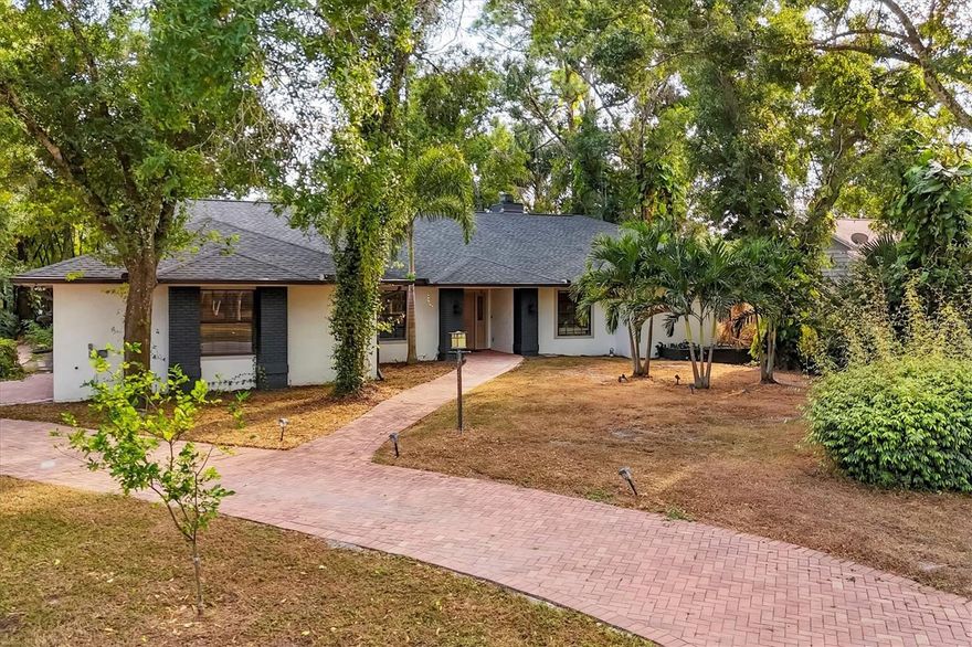 4 BED / 3 BATH POOL HOME featuring 2,590 sqft of living area on a private HALF ACRE LOT, CUL-DE-SAC location, and NEW ROOF (2023) in HIDDEN OAKS NORTH. This boutique enclave neighborhood is highly sought after due to its large custom-built homes, huge lots with canopy trees, and super low HOA fee of just $525/year with NO CDD fees. This property has a large motor court paver driveway for extra parking along with a side load garage that you rarely find any more that adds to the curb appeal. As you enter the home you immediately notice the OPEN CONCEPT FLOOR PLAN, VAULTED CIELINGS, luxurious ENGINEERED HARDWOOD FLOORING, and 4 panel SLIDING GLASS DOORS that open to the lanai and connect the indoor living area to the lanai area seamlessly. The cozy FIREPLACE and SHIPLAP FEATURE WALL with RECLAIMED WOOD SHELVING lends warmth and texture to the space. The true heart of the home is the chef’s kitchen which features a generous L-SHAPED CENTER ISLAND complete with high-end QUARTZ WATERFALL COUNTERS, and TONS OF CABINETRY with large soft-close pull-out drawers making storage a breeze. The breakfast nook features a bay window which allows plenty of light to enter the space and provides great views of the OVERSIZED PRIVATE POOL AND LANAI area. Brick pavers, a large wet bar with 2 beverage refrigerators, and festive café string lights make this the perfect place to entertain friends and family. The flexible floorplan could easily be reconfigured to offer TWO LARGE MASTER SUITES if desired. The spacious primary suite offers a LARGE WALK-IN CLOSET and FRENCH DOORS which open to the lanai. Each of the other 3 secondary bedrooms also boast WALK-IN CLOSETS, making life a little easier. All 3 bathrooms along with kitchen have been thoughtfully renovated with luxury design upgrades so you can begin to enjoy your new home right away. Located near Honore and Bahia Vista, this location offers quick and easy access to DOWNTOWN SARASOTA, SIESTA KEY BEACH, UTC SHOPPING AND ENTERTAINMENT DISTRICT, and great schools. If you have been looking for an updated home that is UNIQUE AND SPECIAL on a LARGE PRIVATE LOT close to all that Sarasota has to offer, this home is a an ABSOLUTE MUST SEE!