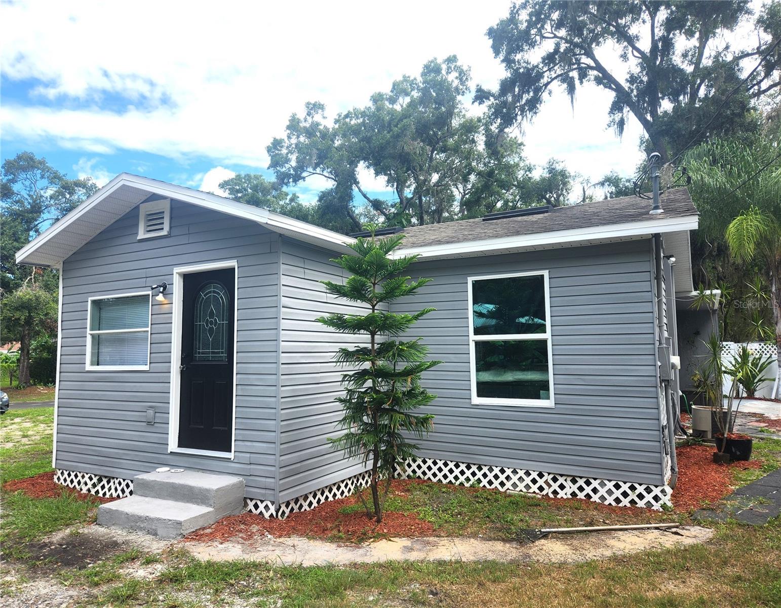 Welcome to this beautifully renovated 2-bedroom home with a versatile bonus room that can easily be converted into a dedicated office and 1 bathroom. This charming property is nestled in the heart of Plant City, just minutes from downtown, shopping, dining, parks, and more. With no HOA or CDD fees, it’s an ideal choice for first-time homebuyers, anyone looking to downsize, or investors seeking a turnkey opportunity.
Situated on a spacious lot, this home offers plenty of room for gardening, outdoor entertaining, and private gatherings. The property also includes a 13x20 workshop, privacy fence, and a driveway with space for two or more vehicles. Recent upgrades include new insulation and drywall in the kitchen and living room, new windows throughout, new subflooring in the bedroom and bathroom, and brand-new kitchen cabinets for a modern, refreshed look.
Currently zoned residential, this property also has potential for mixed-use conversion. Move-in ready and offering generous outdoor space with stylish updates, this home is a perfect fit for a variety of lifestyles.
Seller offering $1,000 credit towards buyer’s closing costs.
Don’t miss out on this gem – schedule your private showing today!