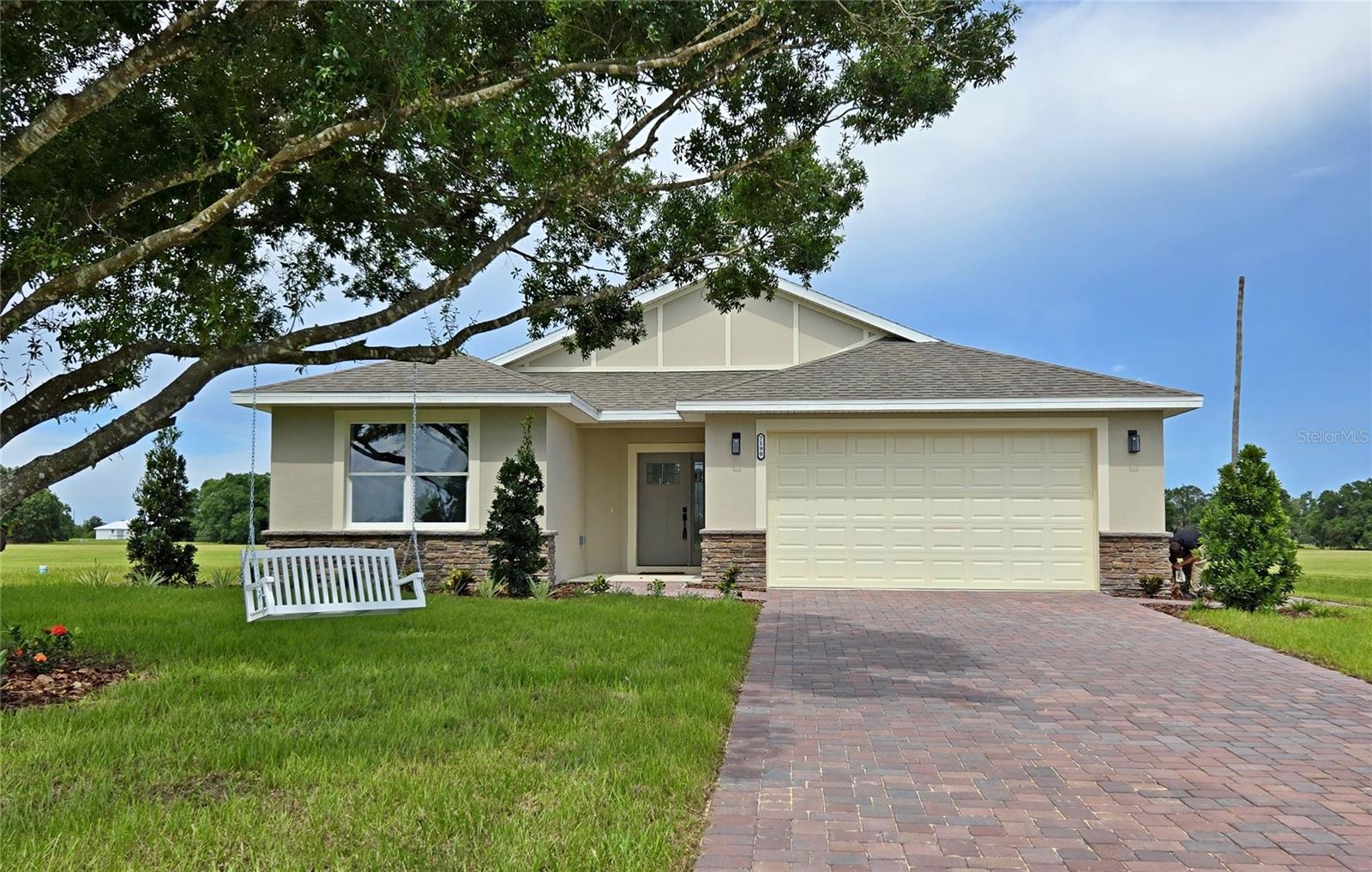 Welcome to an extraordinary 3-bedroom, 2-bathroom single-family home in the Springlake community of Sebring, Florida—a residence that outshines the competition with its premium upgrades and custom builder touches. This stunning home boasts a spacious open floor plan designed for modern living, featuring premium luxury vinyl flooring that flows seamlessly throughout, blending durability with timeless elegance. The gourmet kitchen is a chef’s delight, equipped with sleek granite countertops, high-end stainless steel appliances, and custom cabinetry, ideal for culinary creations and effortless entertaining. Both bathrooms echo this luxury with matching granite finishes and contemporary fixtures, creating tranquil, spa-like retreats. The heart of the home is the inviting living room, where a striking accent wall with a cozy fireplace serves as a captivating focal point, adding warmth and sophistication to the space. Custom finish trim work, including detailed baseboards and door casings, enhances the home’s refined aesthetic, while thoughtfully installed ceiling fans in key areas ensure comfort and energy efficiency. Distinctive stone accents on the exterior elevate the home’s curb appeal, making it a standout in the neighborhood. The open layout maximizes space and natural light, showcasing the bespoke details and designer touches that make this home truly unique. Nestled in the vibrant Springlake community, this residence offers not only unparalleled interior elegance but also the charm and convenience of Sebring living. With its array of premium upgrades and custom features, this home is a rare gem, delivering unmatched quality and style. Don’t miss the opportunity to own this exceptional Springlake masterpiece!