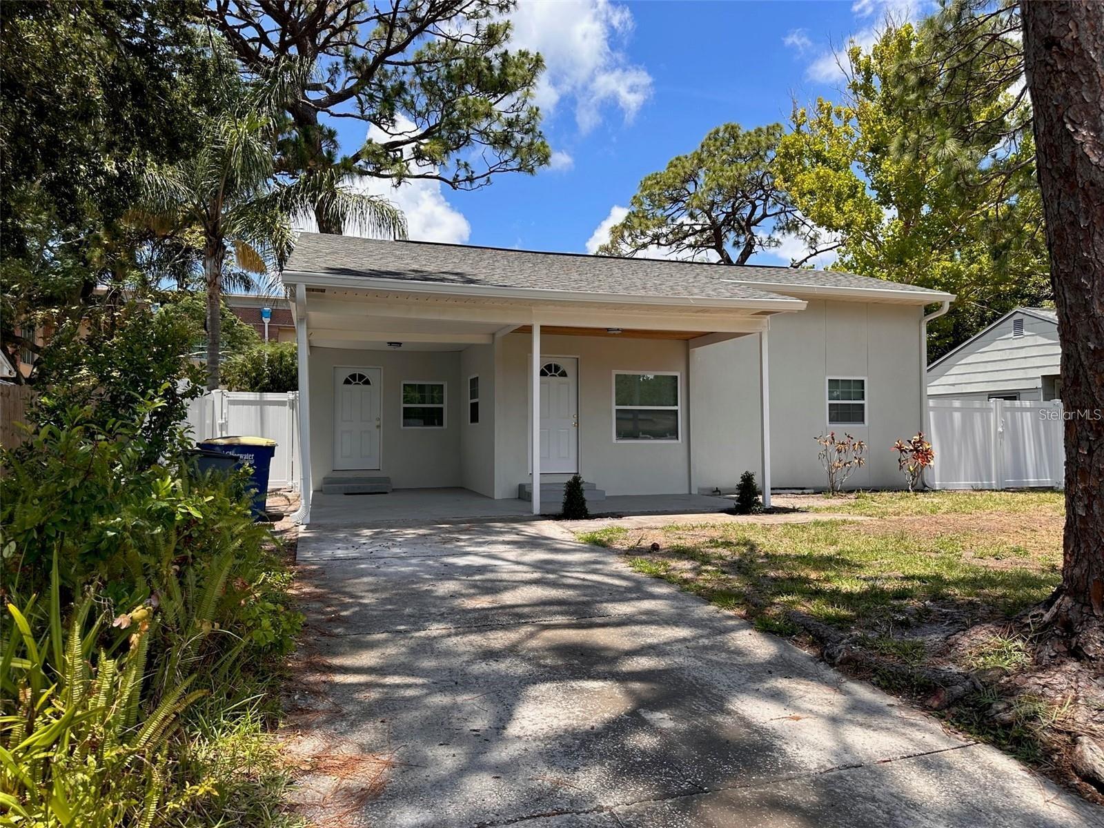 This beautifully remodeled two-bedroom, one-bathroom home offers a perfect blend of modern amenities and comfort. As you enter, you'll be greeted by an inviting open-concept living room and kitchen, designed to provide both connectivity and slight separation for a cozy feel. The kitchen at the heart of the home features custom cabinets, sleek countertops, and stainless steel appliances ready for your culinary endeavors. Additionally, there's a convenient dining just off of the kitchen which leads to the laundry area at the carport entry. The home's upgrades continue with a newer A/C system, newer roof, newer flooring, insulation, and fresh bathroom tiles and fixtures. Outside, you'll find a fully fenced backyard and a paved back patio, ideal for outdoor gatherings. This move-in-ready home ensures everything you need is ready for your enjoyment. Close to US19 and Courtney Campbell Causeway to Tampa and Clearwaters' sugar bright sandy beaches. Ready for move in early October 2025.