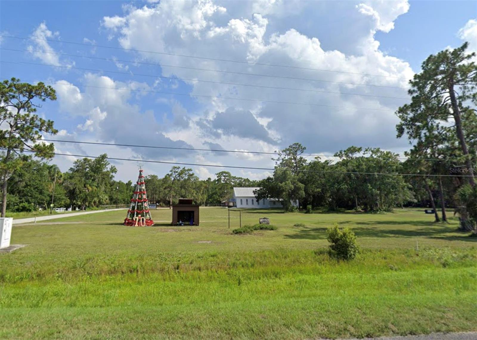 Build Your Legacy on Iconic E Colonial Drive!
This 0.17-acre commercially zoned parcel sits directly infront of the beloved Christmas tree and mailbox in Christmas, Florida—an iconic roadside attraction that draws thousands of visitors year-round to send holiday letters stamped from “Christmas.” With over 10,000 vehicles passing daily along E Colonial (Route 50), the visibility is exceptional. Perfect for a commemorative plaque bearing your family’s name, creating a legacy that lasts. Imagine a butterfly garden with benches, food truck setups, commercial signage, or a unique roadside stop—this flexible-use land offers the opportunity to blend community impact with smart investment.