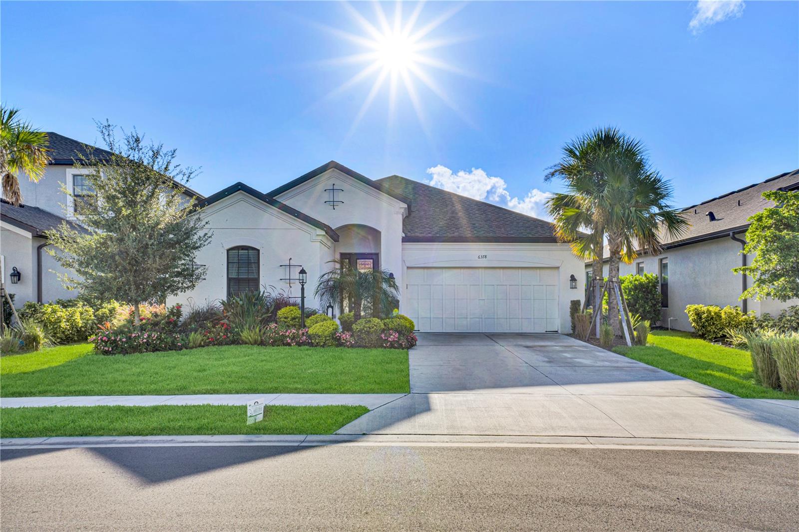 Discover Grandview at The Heights, home to this striking four-bedroom, three-full-bath pool and water view residence. Grandview at The Heights is a gated community with exceptional amenities including a private park with elevated views of Manatee and Sarasota County along with kayaking and paddle boarding on the adjacent Lake Ward. The home features meticulously maintained landscaping with colorful flower beds which leads to an impressive entry through an opaque glass and leaded front door. A circular foyer features a hexagon double tray ceiling with accent lighting and crown molding. The breathtaking water view draws you through the bright kitchen and great room, enhanced by a designer color palette. The kitchen includes stainless steel appliances such as a three-door refrigerator, five-burner gas cooktop, built-in wall oven, microwave, and dishwasher. Quartz countertops, a herringbone backsplash, a butler's pantry, and an oversized island with a farm sink make this space ideal for entertaining. Choose between a formal dining area at the front of the home or use that space as a den and place your dining table in the open area between the kitchen and great room. The expansive great room features an oversized 12’ sliding glass door that pockets out of view, opening to a brick paver lanai with covered and screened deck space. Enjoy the heated saltwater pool with a drip-over spa that seats six, a sun shelf, and peaceful water views. The primary suite offers water views, a bathroom with a glass-enclosed shower, garden tub, double sinks, and a large closet with direct access to the laundry room. The split floorplan provides privacy for the three secondary bedrooms. Community amenities include a resort-style pool, outdoor kitchen with grill, kayak launch, playground, dog park, basketball courts, and walking trails. Conveniently located near UTC shopping, world-famous beaches, downtown Sarasota, Lakewood Ranch Main Street, and Waterside. Experience Florida living at its finest!