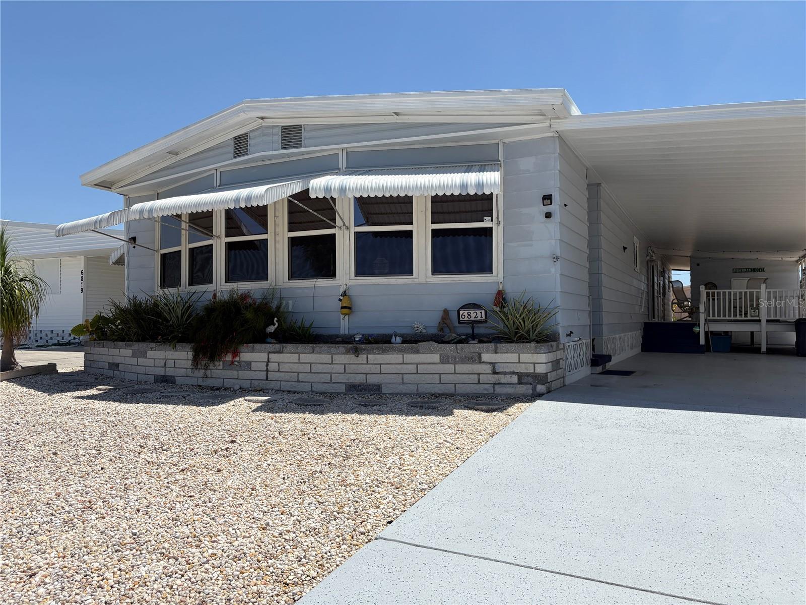 Best Seat in the House! There is room to roam in this large home....3 Bedrooms, 2 full bathrooms, 21X12 Florida Room in the front with wall-to-wall windows overlooking Trailer Estates Marina. It is on an oversized lot with an attached carport, tandem drive and large deck. Inside you will find a living room/dining room combination, kitchen with lots of storage and a dinette area, master bedroom with ensuite bathroom, dressing area & walk-in closet, and convenient inside laundry. Outside two side entrances in attached carport, large storage room for a workshop, extra shed in backyard, covered deck, and easy to care for yard. Down your driveway to the Marina, picnic area overlooking Sarasota Bay, Kayak area, Park has great neighbors already in place and offers bocce ball, shuffleboard many activities, clubs, community pool, exercise room, indoor pickleball court, shuffleboard, dances, dinners, various clubs. Trailer Estates is located near hospitals, banks, eateries, Riverwalk, UTC Mall, Downtown Arts District Benderson Park, hospitals, airport and best of all the beaches always rated among the top beaches in the U.S.
One of the very few Special Park & Recreation Special Tax Districts. You own your lot and there are NO monthly fees. When you send your annual property taxes the tax office returns $1439 of your total tax amount to Trailer Estates to cover your cable, internet, trash pickup, fire and rescue, on site office and park manager, recreational facilities, community pool and clubhouse. Snowbirds....BRING YOUR BOAT - Dock Fees Annually vary 20' $549 to 30' $825
Welcome Home to Trailer Estates!