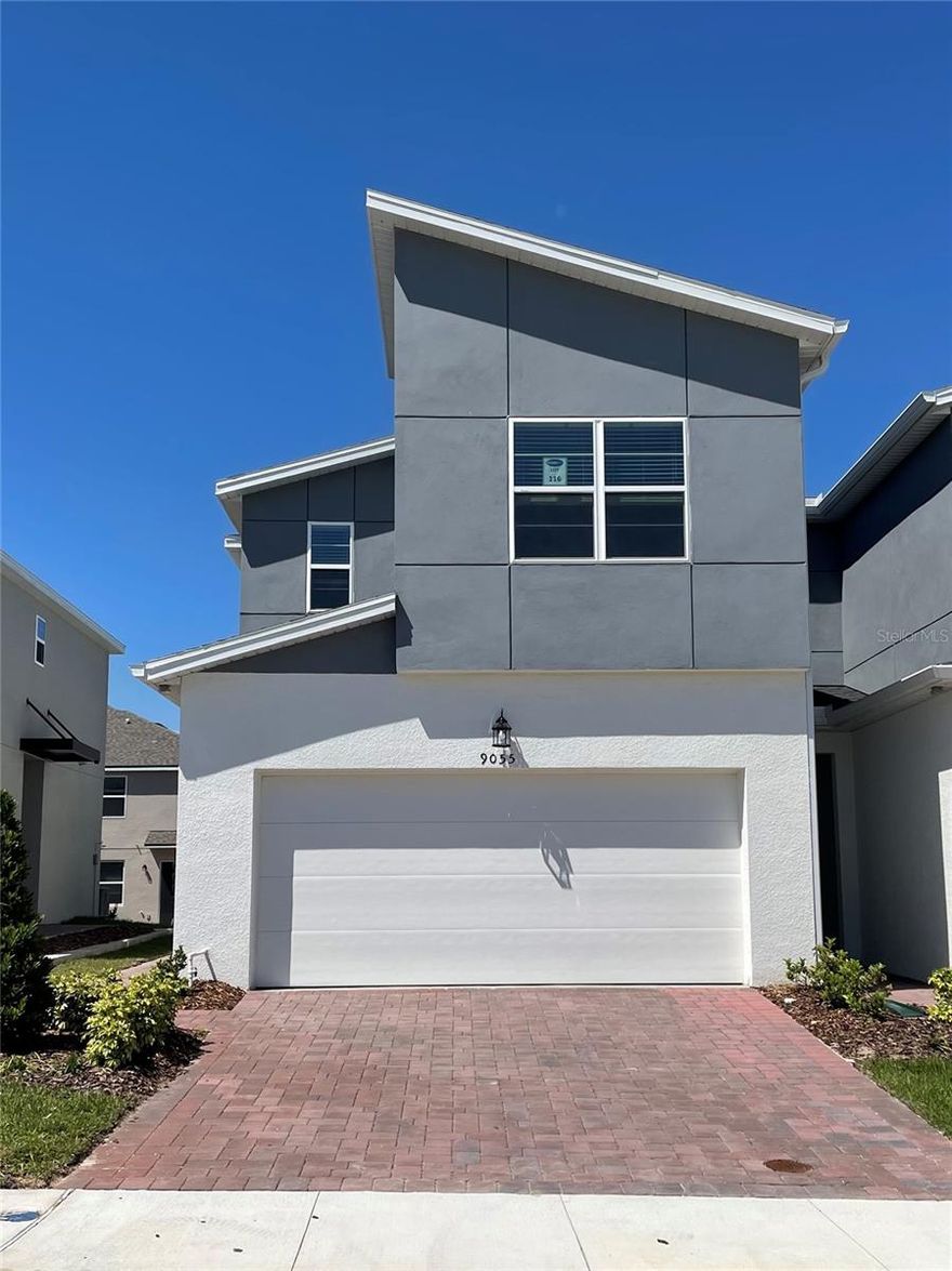 Beautiful corner-unit townhome in a residential-use-only community, offering 3 bedrooms (all upstairs), 2.5 baths, a 2-car covered garage.  Bright natural light enhances the elegant upgraded cabinets in kitchen with dark granite counters , all within an open-concept ground floor connecting the kitchen, dining area, great room, and back patio. Upstairs features a spacious primary suite with two walk-in closets and dual vanities, two additional bedrooms with walk-in closets, a second bath with dual sinks, and a convenient laundry room. Just minutes from Disney, dining, schools and shopping.