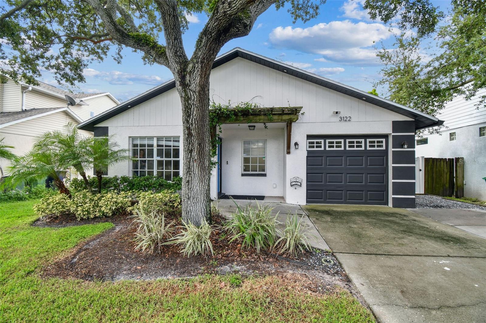 This beautifully updated 3-bedroom, 2-bath home offers open living with an updated kitchen featuring stainless steel appliances and custom cabinetry. The primary suite includes a walk-in closet, barn doors, and en-suite bathroom with a walk-in shower. Two additional bedrooms share an updated guest bath. Enjoy hardwood floors, neutral colors, and a private fenced backyard with a pergola, perfect for entertaining. Additional features include a one-car garage with epoxy floors and AC, and a stacked washer and dryer. Pest & lawn care included in rent. Ideally located less than a mile from Bayshore and MacDill AFB and just minutes to Ballast Point Park, shopping, and dining, this South Tampa gem won’t last long.