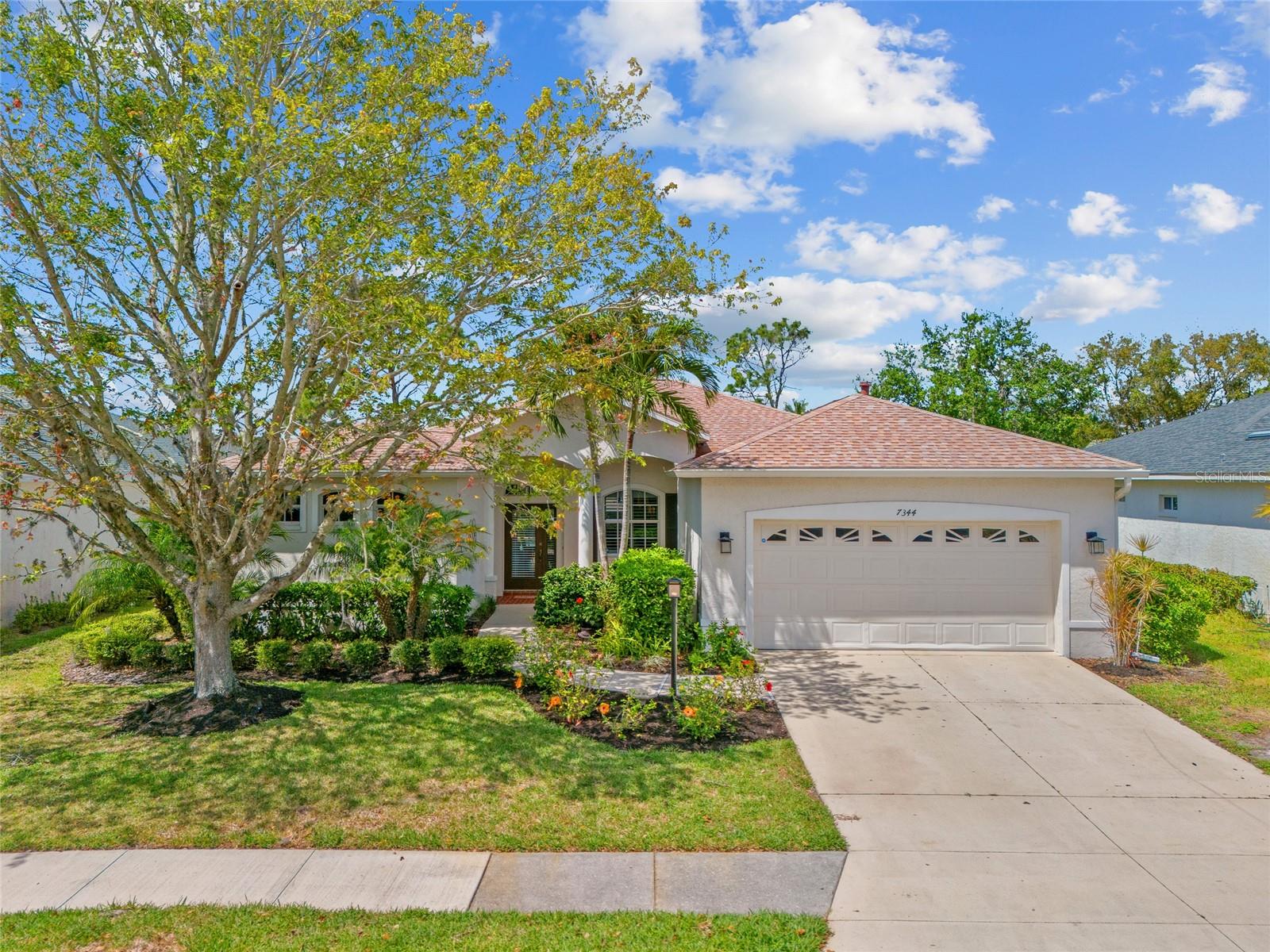 LAKEWOOD RANCH! Beautiful 3 bedroom plus bonus room, 3 bath, 2-car garage pool home in highly desired Riverwalk community of Lakewood Ranch. Professional landscaping surrounds this home providing inviting curb appeal. Modern open floor plan features 2,246 sf of living space, high ceilings, arched entryways, crown molding, plantation shutters, slider to lanai and stunning hardwood floors in the main living area. Well-appointed kitchen offers custom cabinets with pull-out drawers, granite counters, under cabinet lighting, stainless appliances including gas range and breakfast bar. Casual dining nook with large aquarium window and family room with slider both offer lanai and pool views. Generous primary suite features access to lanai, wood flooring, walk-in closet and private ensuite with dual sinks, garden tub, and walk-in shower. Split floor plan provides privacy for all with separate hall leading to two bedrooms and separate full bath. Off the family room you’ll find the office or bonus room and convenient pool bath. Covered lanai with sunshade and screened in pool with pavers boasts true western exposure to enjoy amazing SWFL sunsets and is perfect for entertaining family and guests. This impressive home offers many custom upgrades such as closet organizers in every single closet, newer carpet in bedrooms, inside laundry with extra storage, irrigation system, new hot water heater in 2023, new HVAC and roof in 2021, and water softener salt free added in 2020. Low CDD and low HOA. Lakewood Ranch boasts easy access to I-75 and is nearby metro areas including Tampa and Sarasota, shopping at University Town Center, Sarasota airport, entertainment districts and short drive to world-class beaches. You’ll find fine dining within this friendly neighborhood, along with shopping, parks, golf and nature preserve trails for walking and biking. Don’t miss this opportunity to make this your new Florida retreat!