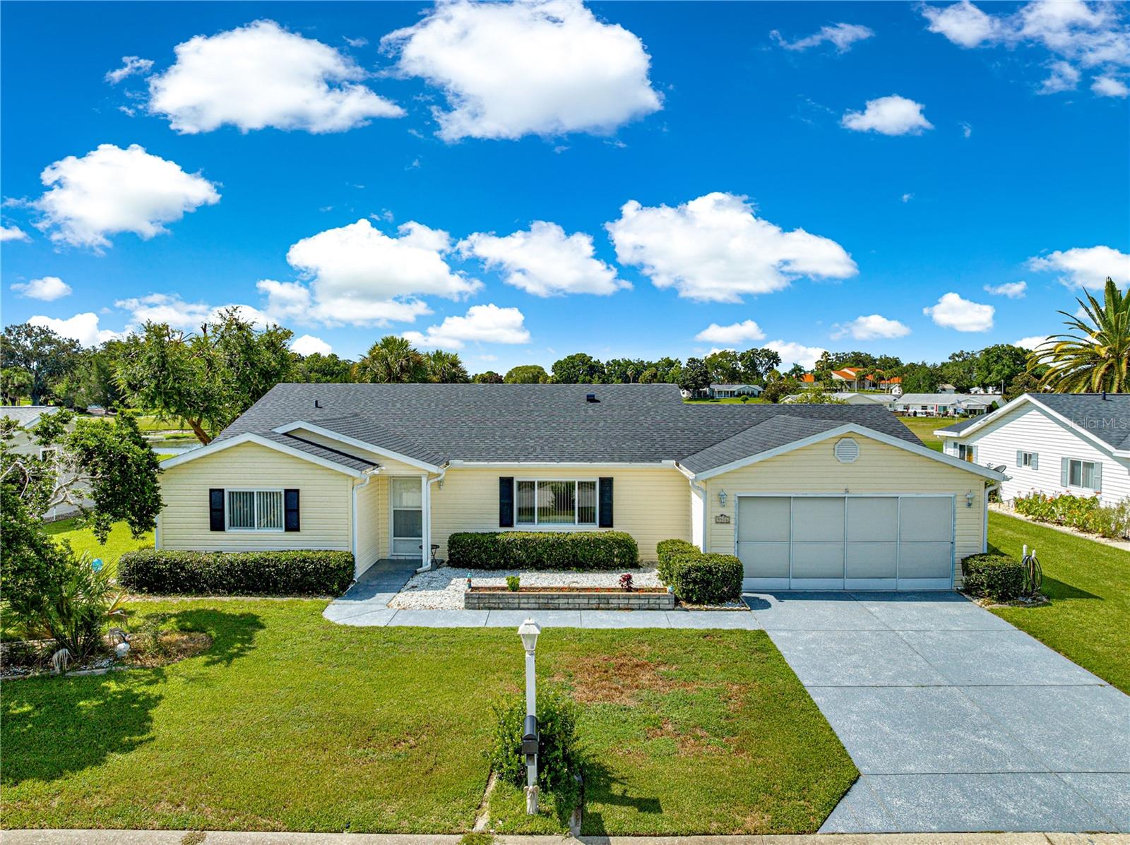Nestled in the desirable 55+ gated community of Spruce Creek South, just two miles from The Villages, this beautifully updated home offers resort-style living with the convenience of nearby shopping, dining, and medical facilities. Enjoy access to the golf and country club, community pool, and a host of amenities. From the enclosed Florida room, take in breathtaking views of the golf course, a serene pond, with unique lighthouse, and cascading water fountains, perfect for entertaining your family and guests. Inside, luxury vinyl plank flooring flows seamlessly throughout home with NO carpeting. The kitchen has been updated with pristine granite countertops and black stainless steel appliances. The home features updated fixtures, both bathrooms have granite countertops as well, with a fully renovated tile shower in the guest bathroom. This home also features a versatile bonus room perfect for an office or hobby space. With a roof replaced in 2021, this move-in ready property blends comfort, style, and an unbeatable location. *** DON’T MISS THIS ONE ***