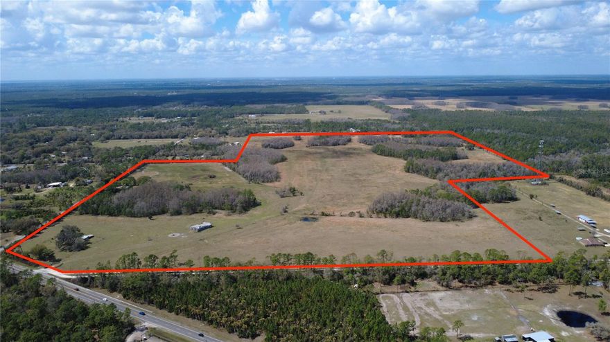 Welcome to 1092 South State Road 415, New Smyrna Beach, FL 32168—three contiguous parcels totaling approx. 157 acres of productive grazing land. The site is utility-ready with septic available and water on, and the mobile home has been removed. On-site assets include a 3,868± sq ft 1958 pole barn, storage units, managed drainage canals, selective wetlands, and stands of cypress. Enjoy private road access, documented easements, and flexible A-1 zoning in unincorporated Volusia County. Whether you plan to build, farm, operate a business, or pursue a rezoning and development strategy, this location—minutes from SR-44—checks the boxes for buyers, investors, builders, and land developers. (Additional Parcels: ID#821001020120 and ID#821001020010.)
