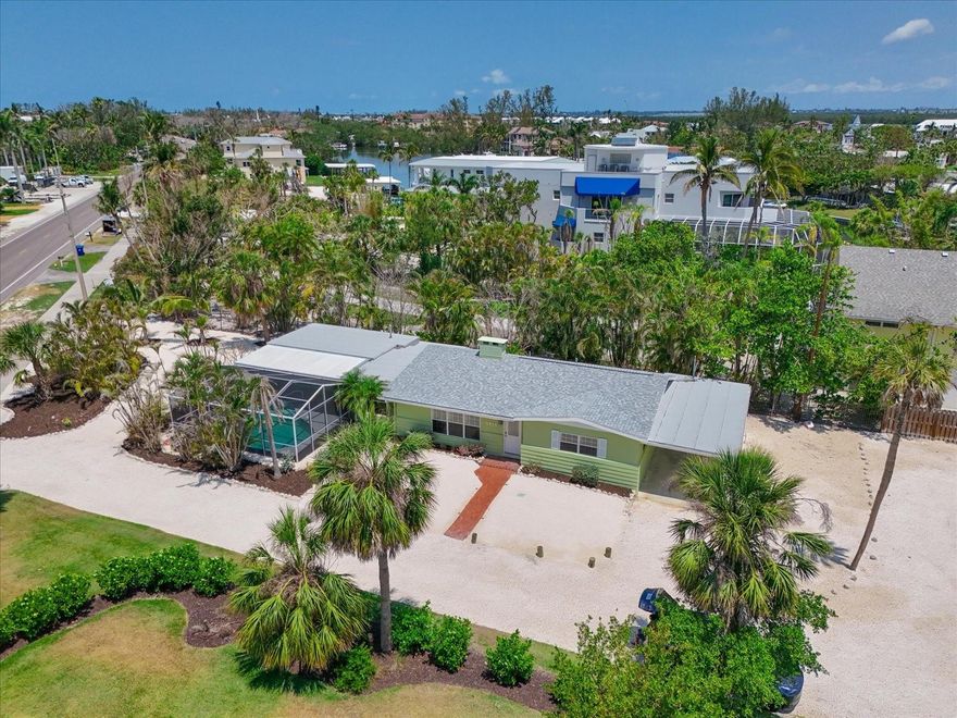 Sought after mid-key cottage home with DEEDED BEACH ACCESS on the barrier island of Longboat Key.  Entering the home, you are greeted by terrazzo floors, wood beam ceilings and a tile accented gas fireplace in the large living room.  An additional room overlooking screened in pool can be used as an office, exercise room or extra space for guests. Newly renovated kitchen with wood cabinets, quartz countertops, new sink and fixtures.  Bathrooms have been completely renovated with beautiful walk-in tiled showers. A built-in bookcase in the living room adds charm with plantation shutters, accent lighting and ceiling fans throughout.  

Completely restored home by licensed general contractor and professionally mitigated after hurricane Helene flood damage.  The house shares a driveway and deeded beach access with 5920 Gulf of Mexico Drive making it a perfect guest house or family compound when purchased together.  Another possibility is to use one as as a rental for an ongoing revenue stream.  The property is being sold As-Is (use FAR-BAR-ASIS-7.