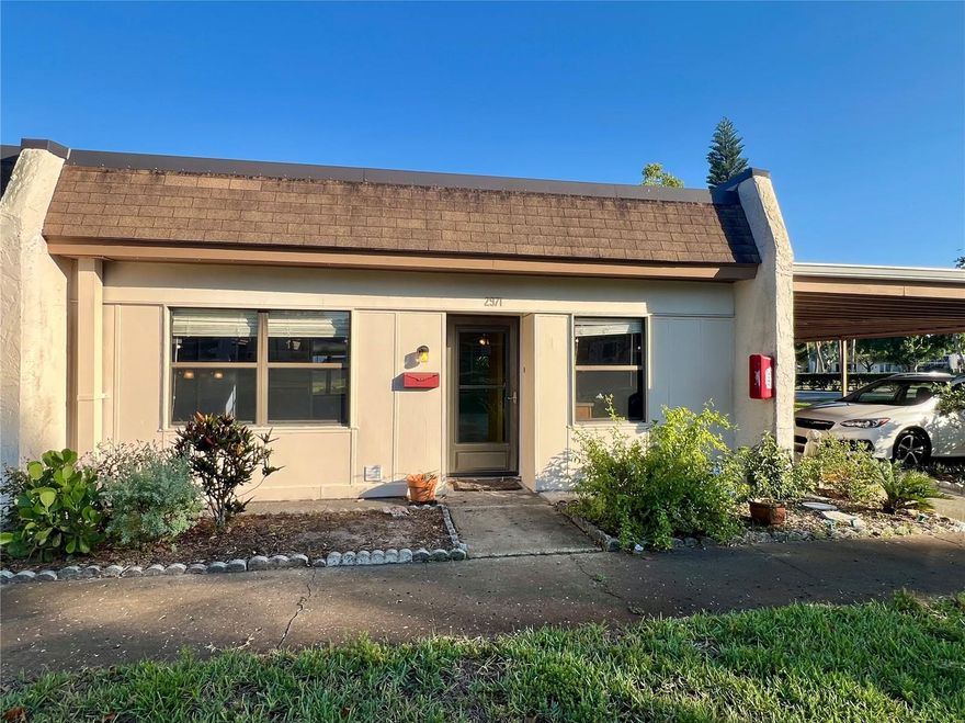 Welcome to maintenance-free living in the highly coveted 55+ community of Mission Hills! This thoughtfully maintained 2-bedroom, 2-bathroom villa offers the perfect blend of comfort, convenience, and peace of mind. Nestled in a prime location within the community, this home features a private rear entrance that opens to a lush, wooded, scenic backyard—all just steps away from the community pool, clubhouse, and ample guest parking. Key Home Features: • Systems & Safety: Equipped with a newer HVAC (2018) and ideally situated in a Non-Evacuation, Non-Flood Zone X—stay high and dry with ultimate peace of mind. • Outdoor Living: Enjoy your morning coffee or host sunset dinners on the private back patio. Includes a dedicated covered carport and an individual utility shed for extra storage. Unbeatable Location & Convenience: • Daily Errands: A mere 5-minute walk to Bayside Bridge Plaza (Publix, Planet Fitness, dining, and shopping). • Commuting & Travel: Just 15 minutes to both Tampa International (TPA) and St. Pete-Clearwater (PIE) airports. • Entertainment & Leisure: 5 minutes to historic Safety Harbor, Ruth Eckerd Hall, and the Phillies Spring Training complex. Plus, you are only 20 minutes from world-class beaches and 25 minutes to vibrant Downtown St. Pete. Resort-Style Community Amenities: Mission Hills is renowned for its lush, mature landscaping and vibrant social scene. The active clubhouse serves as the community hub, offering a library, fitness equipment, billiards, and shuffleboard. Dive into the large, heated community pool, or join your neighbors for bingo, ice cream socials, and exciting planned excursions