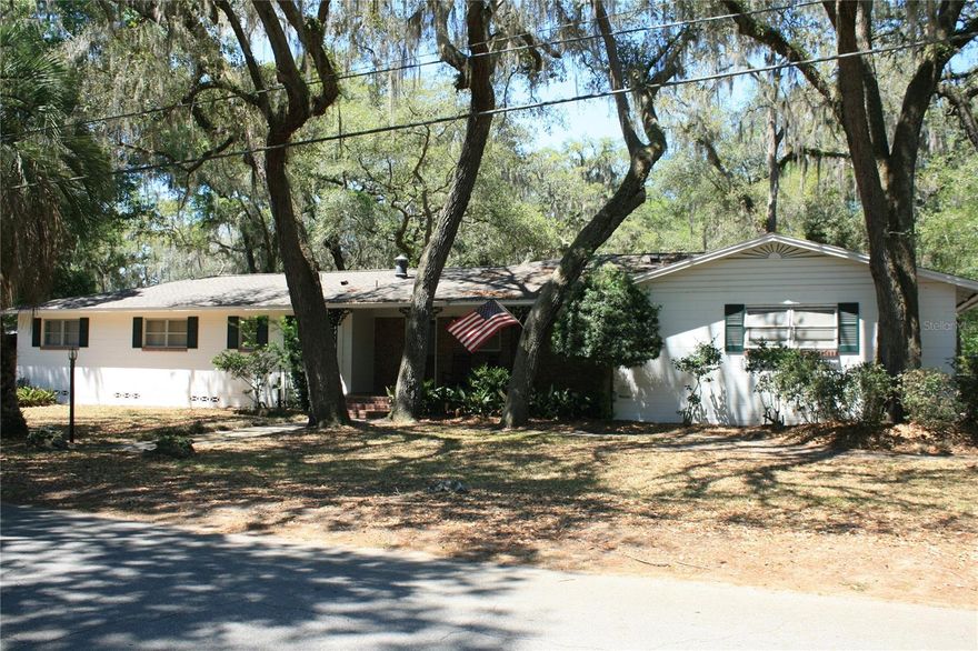 Rare Opportunity Near the University of Florida! This spacious one-story concrete block home offers the perfect combination of classic character, modern updates, and incredible investment potential. Built in 1963 and situated on a large .64-acre corner lot shaded by beautiful mature oak trees, the property includes the possibility of a separate additional lot for another home or future development opportunity. Inside, you’ll find over 3,500 square feet of total area featuring 5 bedrooms and 3 remodeled bathrooms, providing plenty of room for a large family, multi-generational living, or rental flexibility. Real hardwood floors run throughout much of the home, adding warmth and timeless appeal. The spacious kitchen offers an abundance of storage cabinets and workspace for everyday living and entertaining. Outdoor living shines with an impressive 40’ x 20’ screened swimming pool, perfect for relaxing, hosting gatherings, or enjoying Florida living year-round. Additional highlights include a new roof, oversized 2-car garage, and a highly desirable location close to the University of Florida, shopping, bus routes, and the UF football stadium.
Whether you are searching for a spacious family residence, game-day retreat, or outstanding investment opportunity, this unique property offers endless possibilities in one of Gainesville’s most convenient locations.