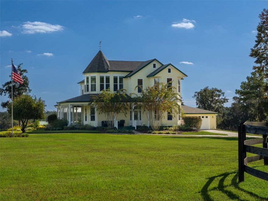Perfectly situated less than 10 minutes from the World Equestrian Center, this turn-key 30-acre farm in Ocala is fully fenced and thoughtfully designed with horse amenities that combine functionality and comfort. Featuring 20 lush paddocks and a center-aisle barn with 10 stalls, designed for practicality and care. The finished barn is insulated behind its beautiful tongue-and-groove ceiling, making it comfortable in every season. It also includes fans throughout for excellent ventilation, a feed room with laundry space, tack room, bathroom, wash racks with hot water, grooming areas, a fly spray system, and a water filtration system, offering every convenience for both horse and rider. Additional equestrian facilities include an arena with premium GGT footing and an irrigation system, run-in sheds, and an equipment/storage building. A pond with a beautiful fountain adds to the charm of the property’s landscaped grounds. The main residence is a two-story Victorian-style home with a welcoming wraparound porch and an attached two-car garage. Inside, you’ll find 4 bedrooms, 3 full bathrooms, a sunroom, and a cozy fireplace that enhances the home’s inviting atmosphere. The kitchen features granite countertops, solid wood cabinetry, and a walk-in pantry, offering plenty of counter and storage space. Mahogany wood flooring flows throughout much of the home, complemented by tile and carpet in select areas. Step out back and enjoy a resort-style saltwater lap pool complete with a waterfall feature, perfect for relaxing after a day at the barn. The property also includes a guest suite with a private entrance, offering 2 bedrooms, 1 bathroom, a kitchen, living area, and laundry space, ideal for guests, staff, or extended family. With its park-like setting, proximity to the World Equestrian Center, and convenient access to shopping and amenities, this property offers everything needed for both an active equestrian lifestyle and peaceful country living.