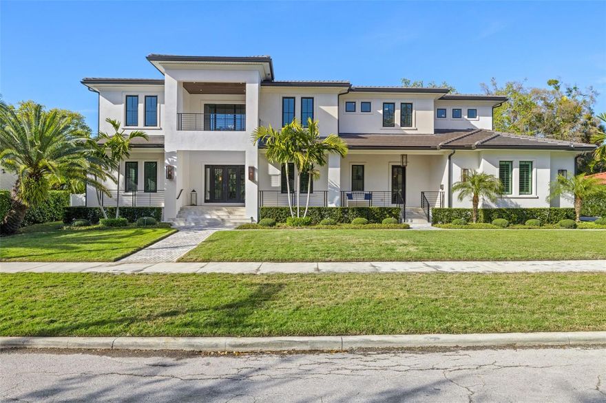 Presenting an unparalleled custom estate, built in 2020 in Transitional Style, nestled within the highly coveted Beach Park neighborhood in South Tampa. This residence embodies a timeless, harmonious, and inviting elegance rarely seen. Thoughtfully designed without
 compromise, the collaborative vision of the owners, the esteemed builder's craftsmanship, and tasteful details converge to create this remarkable home. This two-story block estate spans 6,000 SF., offering 5 en-suite bedrooms (one transformed into a media room), 5 & 2 half baths, and 3-car side-entry garage. A striking first impression is made with its welcoming two-story front porch and terrace, adorned with travertine floors and gas coach lamps that cast a warm glow upon the exterior landscaped surroundings, paved walkways, and driveway. Immerse yourself in a realm of comfort and refinement, greeted by an elegant foyer, soaring ceilings, statement staircase, and front and center views of the outdoor oasis. The expansive layout effortlessly accommodates a formal dining room featuring a built-in buffet with two wine coolers, a secluded office space, social areas on the right wing, and a serene, private Mother-in-Law suite on the left. The gourmet kitchen is a dream for culinary enthusiasts, equipped with premium elements including a substantial island with wrapping cabinetry underneath, quartzite countertops, pot filler, double oven, 6-burner gas range, and professional-grade Thermador appliances. Adjacent, the breakfast nook offers ample space and direct access to the lanai. Discover the concealed butler's pantry, cleverly tucked away behind the kitchen, ideal for your catering staging needs and wine collection, with its separate service entrance and convenient mudroom. Exquisite upgrades throughout, such as tray and coffered ceilings, crown molding, expanded baseboards, superior plantation shutters, hardwood floors, stylish lighting fixtures and chandeliers, quartzite and marble countertops. The family room seamlessly blends spaciousness with coziness, featuring volume pocket sliding doors, fireplace, and peaceful views. Retreat to the expansive master suite boasting a luxurious bath with marble floors and waterfall edge countertops, Restoration Hardware lighting, oversized walk-in closet with wardrobe and accessories organization system and island. Three secondary bedrooms offer en-suite baths and walk-in closets with built-in organizers. The expansive upstairs game room has been converted into a fully functional home gym with a wet bar. The outdoor oasis includes a massive, covered lanai with travertine upper and lower decks, resort style pool and spa, lounge and dining spaces, fire pit, professional outdoor kitchen, and pool bath. You will appreciate the owners’ investment in lush, professional landscaping. The backyard displays artificial turf on the left side, where your pets can roam free while you host al fresco parties on the right side in the oversized garden, which is uncommon to find in South Tampa. Fenced-in for privacy and leisure activities. Additional amenities: upstairs laundry, storage, surround sound, state of the art Control-4 smart home technology and security system, water softener, full home generator, upgraded fire sensors. Slate tile roof for exceptional durability. Garage with finished epoxy floors and built-ins. Minutes from downtown, airport, beaches, cultural center, business district, dining, entertainment, and in top-rated school district.