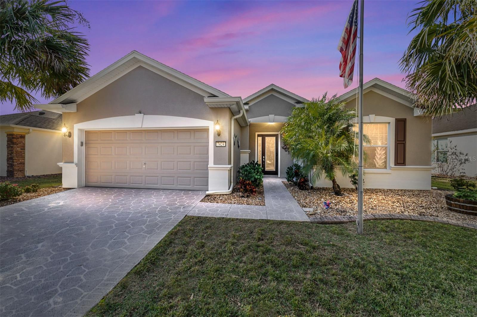 Welcome home to this beautiful well appointed Sheridan Model. Lots of upgrades to enjoy! As you approach this home you will be met with professional landscaping including stamped concrete curbing, Decoratively coated drive and walk way, long lasting landscape rock, mature palm trees, and a custom beveled glass Entry door! As you enter you will notice over-sized tile laid diagonally, and quality laminate flooring, (No carpet) ceiling fans throughout, Lots of natural light in the main living area thanks to the perfectly positioned solar tube and generous sized windows. Granite countertops, Custom backsplash, Stainless Steel appliances, washer and dryer. The Florida room boasts full walls of windows that can be enjoyed opened, or closed! The Florida room has been enclosed correctly with sufficient A/C vents. The HVAC system was replaced new in 2018 AND up-sized to easily accommodate the additional living area even on the hottest summer days! Ceramic tile floor that has been professionally raised to delete the 4" step down when entering the the Florida room. The fenced back yard is great for your furry friends and offers a beautiful custom paver patio and an appealing seating wall. There is also a large remote controlled awning that covers the patio and affords great shade to the Florida room in the summer months. Turn on the hidden water feature to enhance your outdoor relaxation. This home offers many other features like the water softener, retractable hidden screened door on entry door, 2 Large LED wall mounted TV's in living room and bed room. If you are looking for an unmatched lifestyle of endless activities, social events, clubs and fun, Stone Creek Golf & Country Club certainly fits the bill! The residents all agree this is the place to be in North Central Florida. Besides having plenty to do for your perfect 55+ lifestyle, it is also around the corner from one of the best parks in the area (Shalom Park) and plenty of shopping! Publix, Aldis, Walmart, many restaurants and shopping plazas, and other amenities are just around the corner. Also, Stone Creek is a very short drive to excellent medical facilities, the famous World Equestrian Center, and Downtown Ocala. Not far from Gainesville or The Villages, and slightly over an hour to get to Tampa or Orlando. The pictures and description don't do this home justice! Come see it in person soon before this opportunity goes away. (2 photographs have been virtually staged)