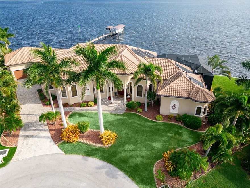 Make Life Even Easier, Now Being Sold TURNKEY!! Experience the ultimate waterfront living on the Myakka River! This stunning 4 bedroom, 4.5 bath home, built by renowned Fero Construction, offers an impressive 294 feet of waterfront and is situated on a cul-de-sac tip lot. Upon entering through the magnificent mahogany doors, you'll be captivated by the breathtaking river views that greet you. Meticulously crafted with an open concept design, you will be immediately impressed with the soaring 16ft tray ceilings, Travertine flooring, and dramatic solid concrete pillars. 10ft telescoping doors throughout tuck away to bring the outside in. Indulge in the ultimate culinary experience with the exquisite chef's kitchen featuring solid cherry cabinets, breakfast bar, granite counters, wine fridge, top-of-the-line Dacor appliances, a propane-fed cooktop, Mele coffee maker, and walk-in pantry. The living room, dinette with an aquarium window, formal dining, and game room flow seamlessly into the kitchen, creating the perfect space to entertain or relax with your family and friends. Each space has sliding doors that lead to the lanai. Indulge in the breathtaking views of the river from the comfort of your spacious primary bedroom, which offers access to the lanai through two sliding doors. The luxurious ensuite bathroom boasts dual sinks, a vanity, jetted tub, Roman shower, and a custom walk-in California closet. Each of the three guest bedrooms offers comfort and privacy, with en-suite bathrooms and one versatile room perfect for a home office or den. Step out onto the expansive lanai with custom pavers and take in the spectacular views of the Myakka River through panoramic screens. Take a dip in the heated saltwater pool or unwind under the covered portion of the lanai. Outside, a 200ft Trex dock leads to not only a 16,000-pound boat lift but also a separate lift for jet skis. It's the perfect setup for enjoying some outdoor fun! Plumbing and electrical connections have been added for your convenience. The oversized 3-car garage includes sliders overlooking the water, storage cabinets, and a utility sink. Additional features of this spectacular home include a whole house generator, zoned cooling, high-impact windows and doors, water softener with reverse osmosis, and so much more! Don't miss out on the opportunity to own this exquisite piece of paradise! This home is perfect for anyone who seeks luxury, sophistication, and breathtaking views. Take the virtual 3D tour and imagine yourself in this stunning home today!