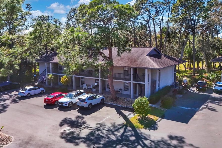 Enjoy a relaxed Florida lifestyle in this one bedroom, one bath end unit condo in the heart of The Meadows, a calm oasis of acres of green space and nature preserves. This Quail Hollow home makes the perfect vacation getaway or a full-time residence for one or two! This maintenance-free community is surrounded by walking paths, mature trees, ponds, lakes and golf courses. Entering this first-floor unit, you are greeted by the warmly updated space with wood-look flooring and gorgeous treed and green views from the living room sliding doors. The primary bedroom has a large closet and pocket door to the adjacent bathroom. The well-appointed bathroom enjoys a new quartz vanity, sink, lighting and step-in shower.  Smartly designed, the shower has the water control located so you don’t have to reach through the spray to adjust. A fully updated kitchen which has been opened up to the living space makes for easy entertaining.  The extended quartz counter creates a cozy breakfast bar including load of under counter storage, new white shaker cabinetry, white dimensional subway tile backsplash, and new appliances create a home cook’s happy place with an end unit window for extra natural light. Convenient interior laundry closet with stackable washer and dryer. HVAC with humidistat 2017, water heater 2017, roof 2014. Step into the spacious screened lanai with verdant green and towering tree vistas, with room for al fresco dining and lounging with beautiful sunsets and an added bonus of a locked storage closet. A private garden area allows for extension of the living area with lovely views. Quail Hollow has a heated neighborhood pool, for a cooling dip or a festive beverage with neighbors. Whether you are strolling across the street to pickleball, basketball, and fitness trails, or biking to the newer fitness center, additional pickle ball courts, top Har-Tru tennis facility, Jr. Olympic pool and spa or the golf courses, this condo provides the perfect Florida lifestyle, carefree and activity-filled. Private dog park and free lending library.  The convenient Village Shops less than a mile away offers a charming collection of restaurants, neighborhood pub, bank, dentist, massage, salon, market and day spa. The Meadows is just minutes by car to The Mall at University Town Center, Nathan Benderson Park for water sports and outdoor festivals, a weekly Famer’s Market, and world-class athletic competitions, Mote SEA Aquarium, Whole Foods and Trader Joe’s for fun grocery shopping, and endless dining options. A short drive to the world class beaches of Siesta Key and Lido Key and the vibrant art, culture, dining and nightlife of downtown Sarasota. Flood zone X above flood plain for peace of mind.